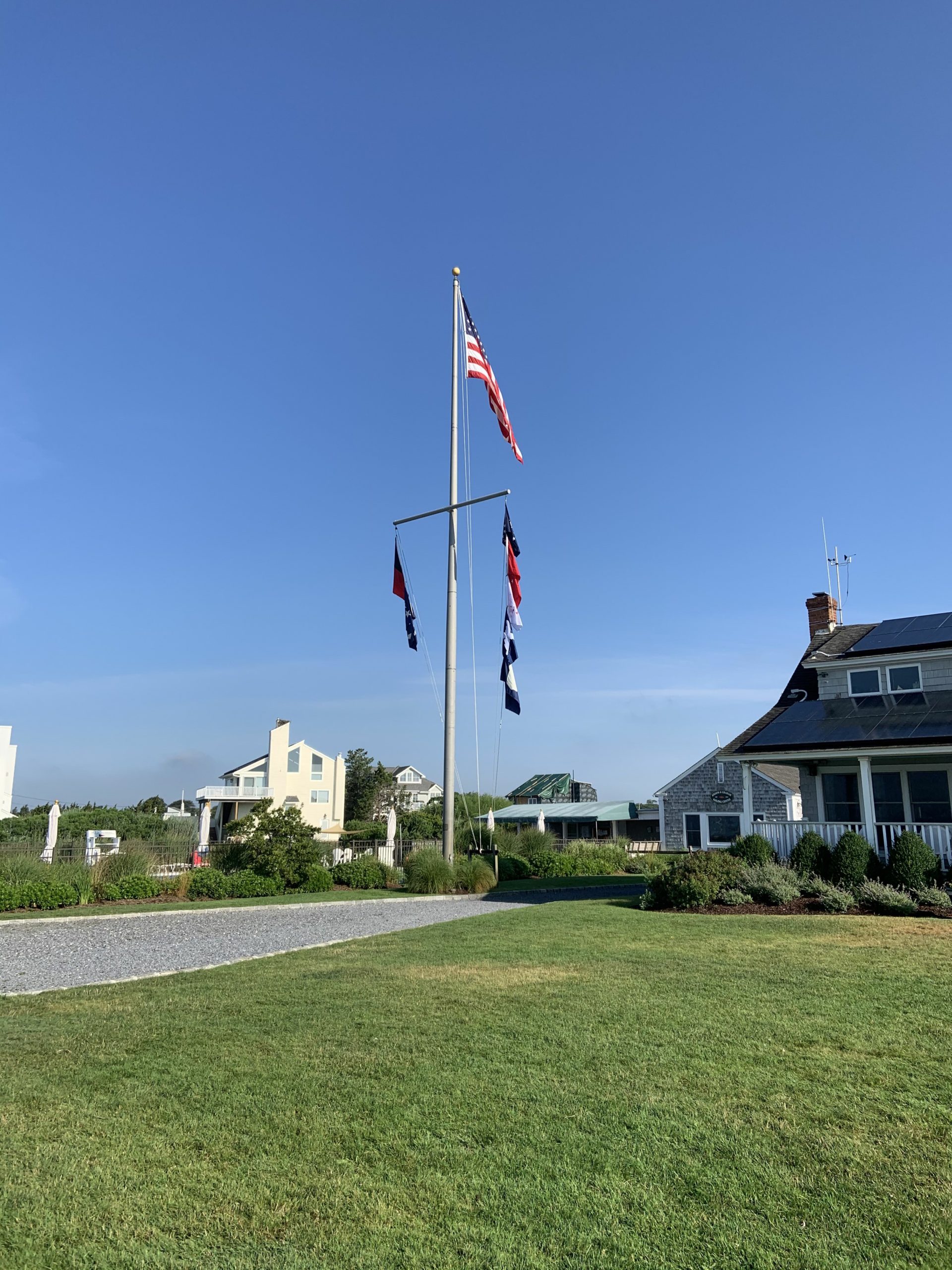 The flagpole and clubhouse at Westhampton Yacht Squadron.
