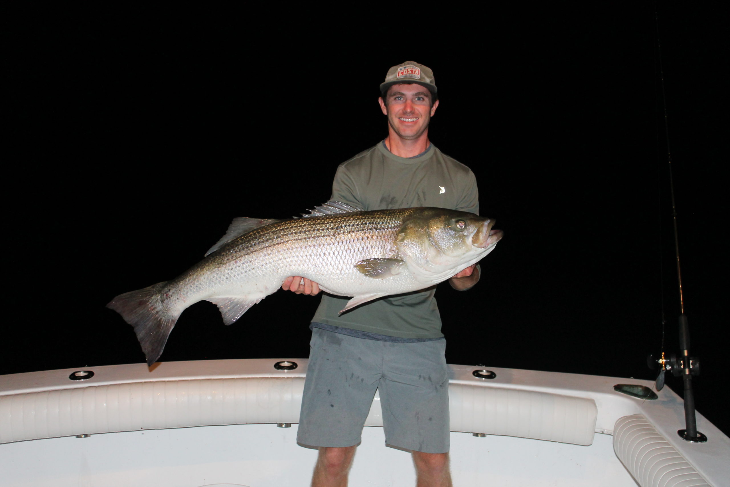 Hunter Wilcox with a big striped bass caught while fishing at night off Montauk Point with Capt. Ben McCarron of Push The Limit Sportfishing.