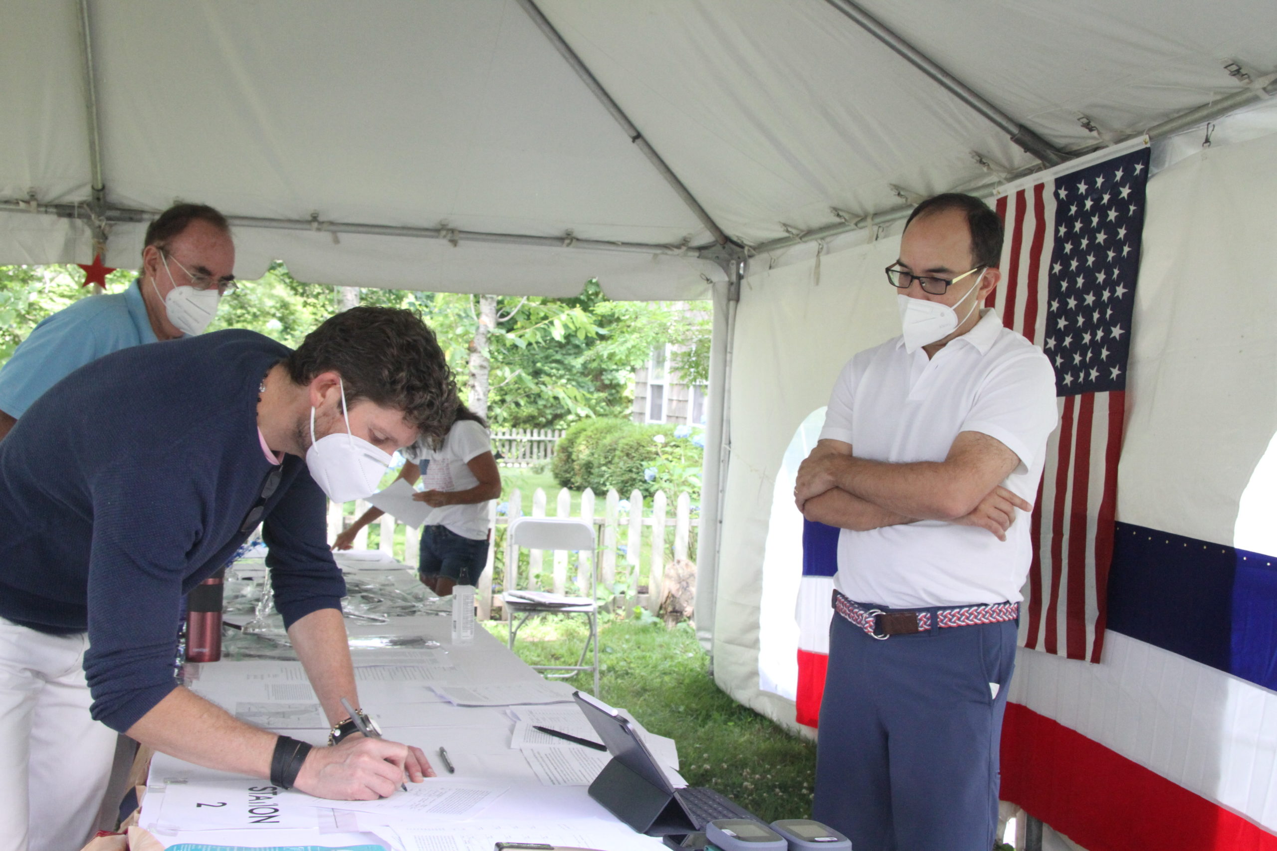 Citizens for the Preservation of Wainscott co-founder Alexander Edlich, right, looked on as Wainscott resident Simon Kinsella signed the petition to call for an incorporation vote. 