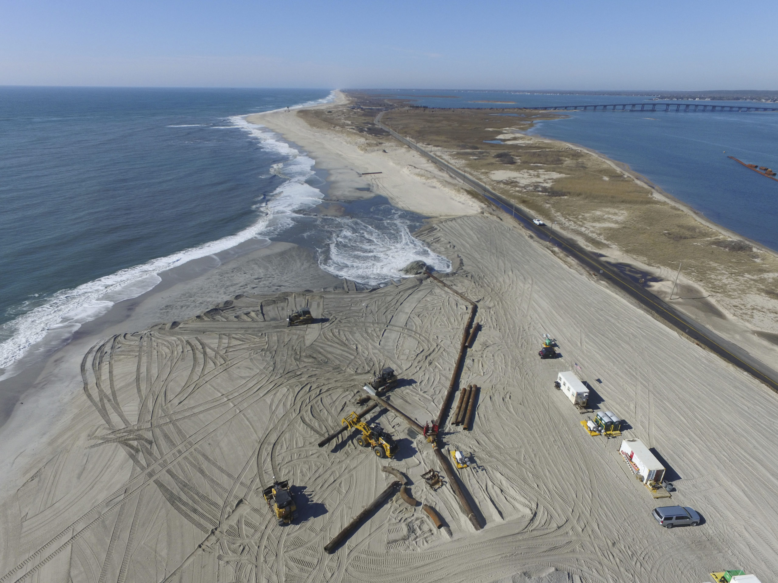 Crews pump hundreds of thousands of cubic yards of sand onto the beach just west of theShinnecock Inlet in Hampton Bays in February.  PRESS FILE