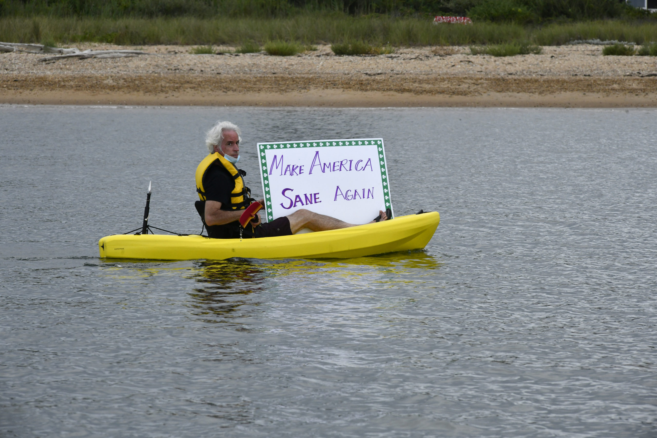 Kayaker Thomas Byrne shows his support for presidential candidate Joe Biden at 