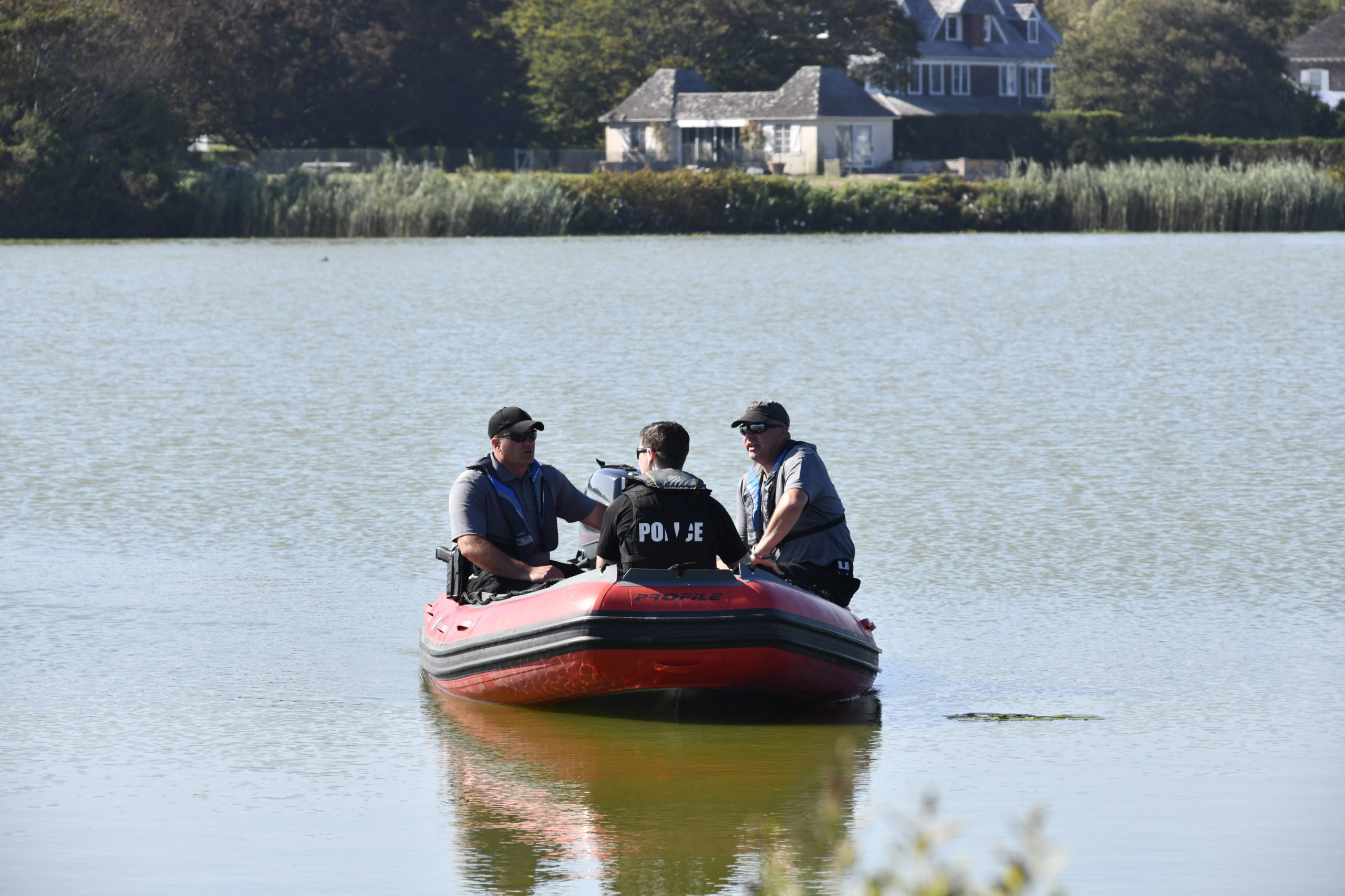 Police on Lake Agawam on Saturday afternoon in advance of Donald Trump's visit for a fundraising event.  DANA SHAW