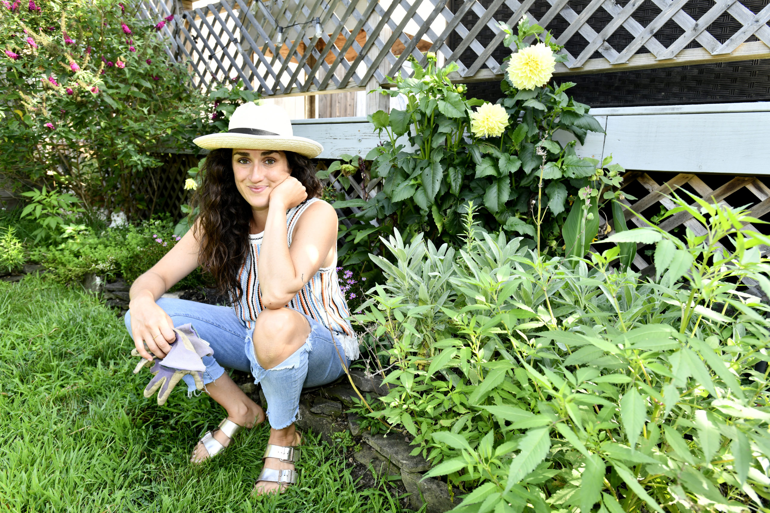 Jenn Neubauer with her dahlias in her garden.   DANA SHAW