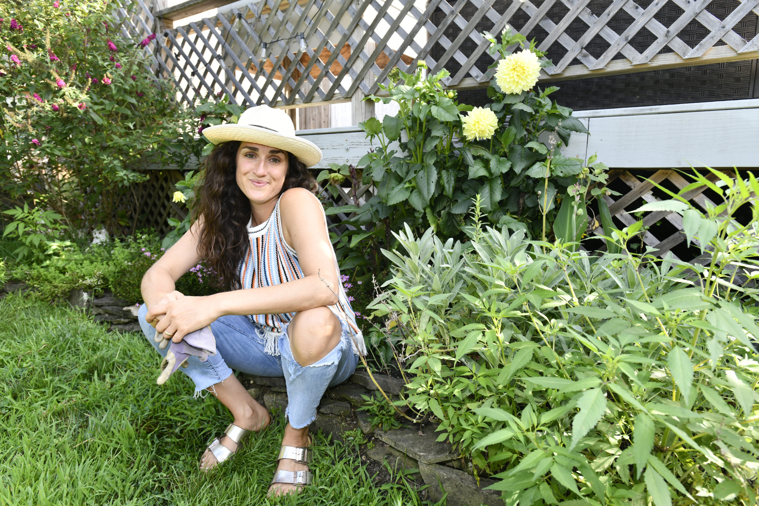 Jenn Neubauer with her dahlias in her garden.   DANA SHAW