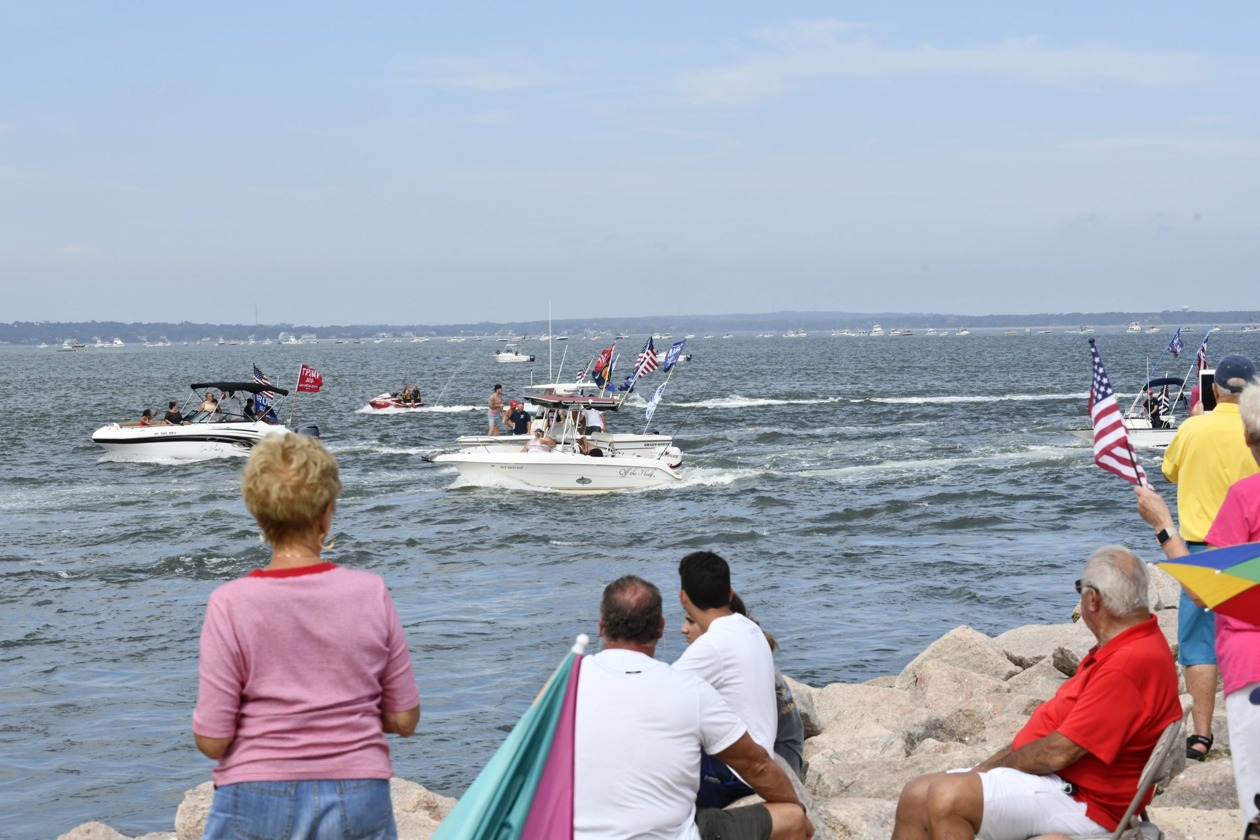 Supporters of President Donald Trump line the jetties, docks and bridges in Hampton Bays on Sunday. 