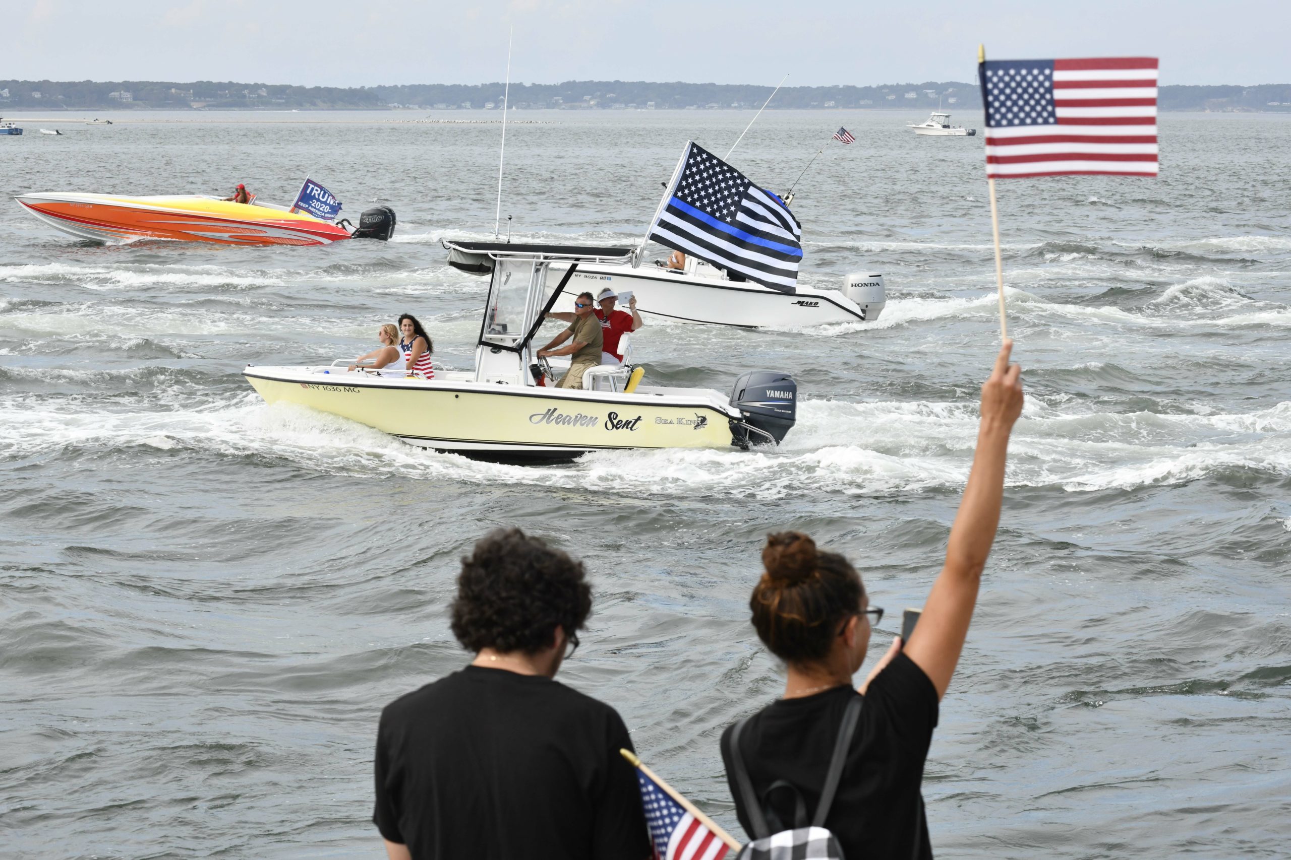 Supporters of President Donald Trump line the jetties, docks and bridges in Hampton Bays on Sunday. 