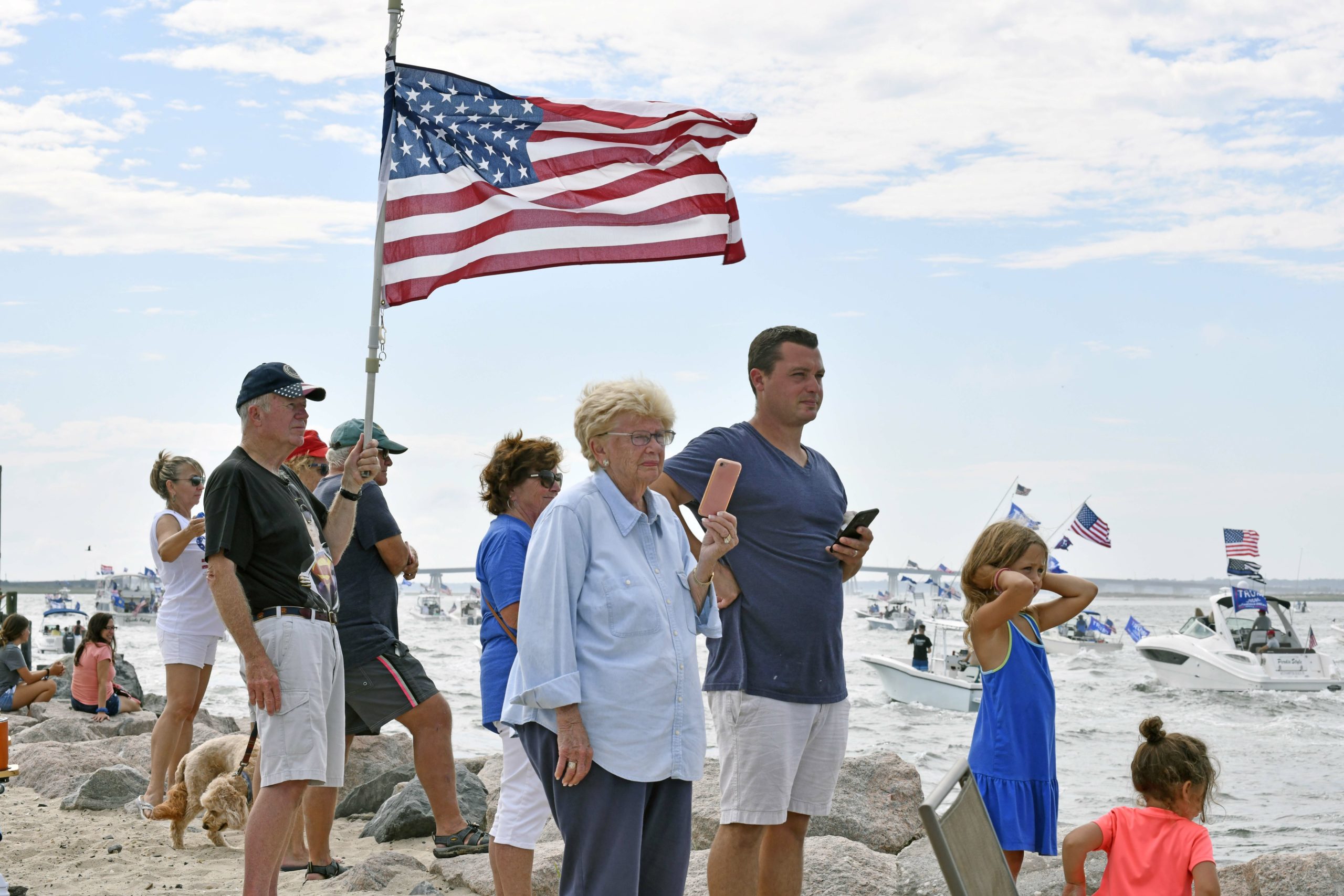 Supporters of President Donald Trump line the jetties, docks and bridges in Hampton Bays on Sunday. 