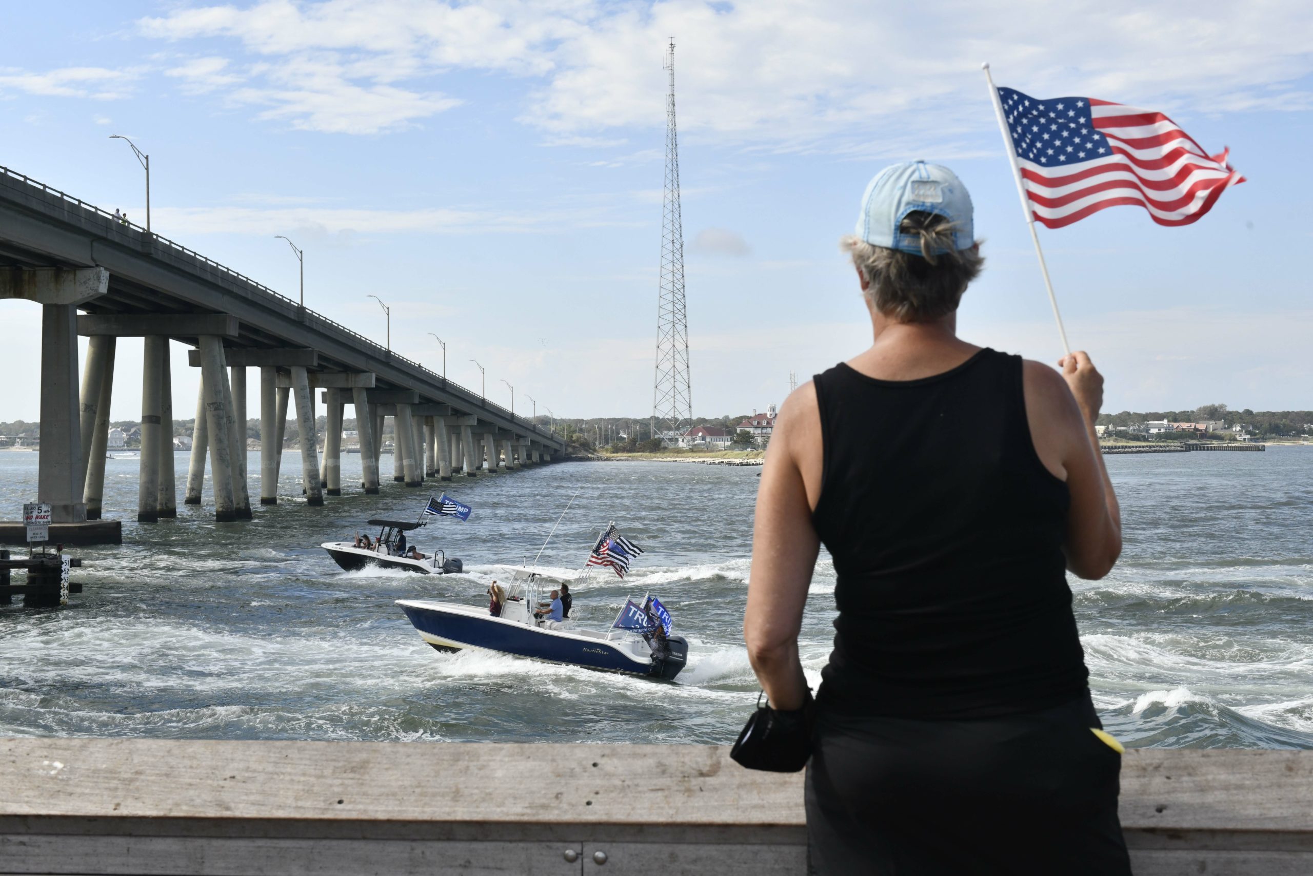 Supporters of President Donald Trump line the jetties, docks and bridges in Hampton Bays on Sunday. 