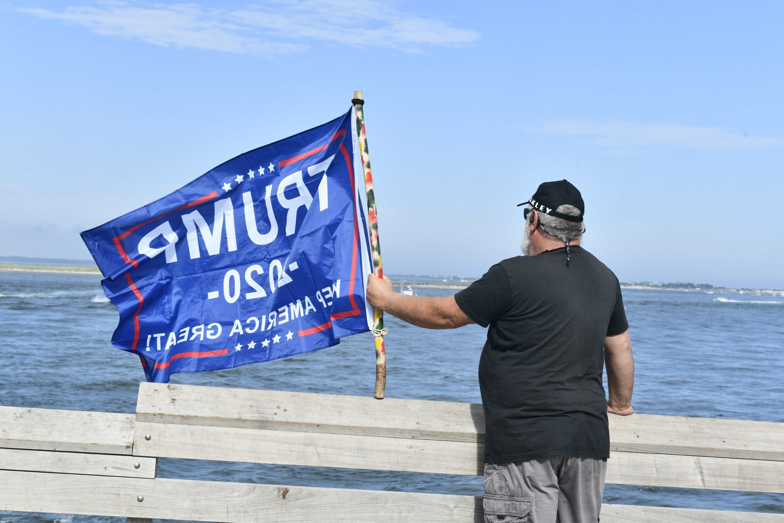 Supporters of President Donald Trump line the jetties, docks and bridges in Hampton Bays on Sunday. 