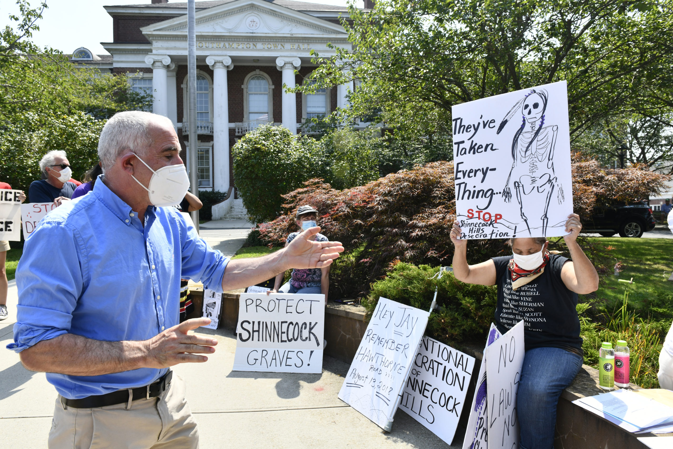 Protesters confront Southampton Town Supervisor Jay Schneiderman about the protection of Shinnecock burial sites at Southampton Town Hall on Tuesday afternoon. DANA SHAW