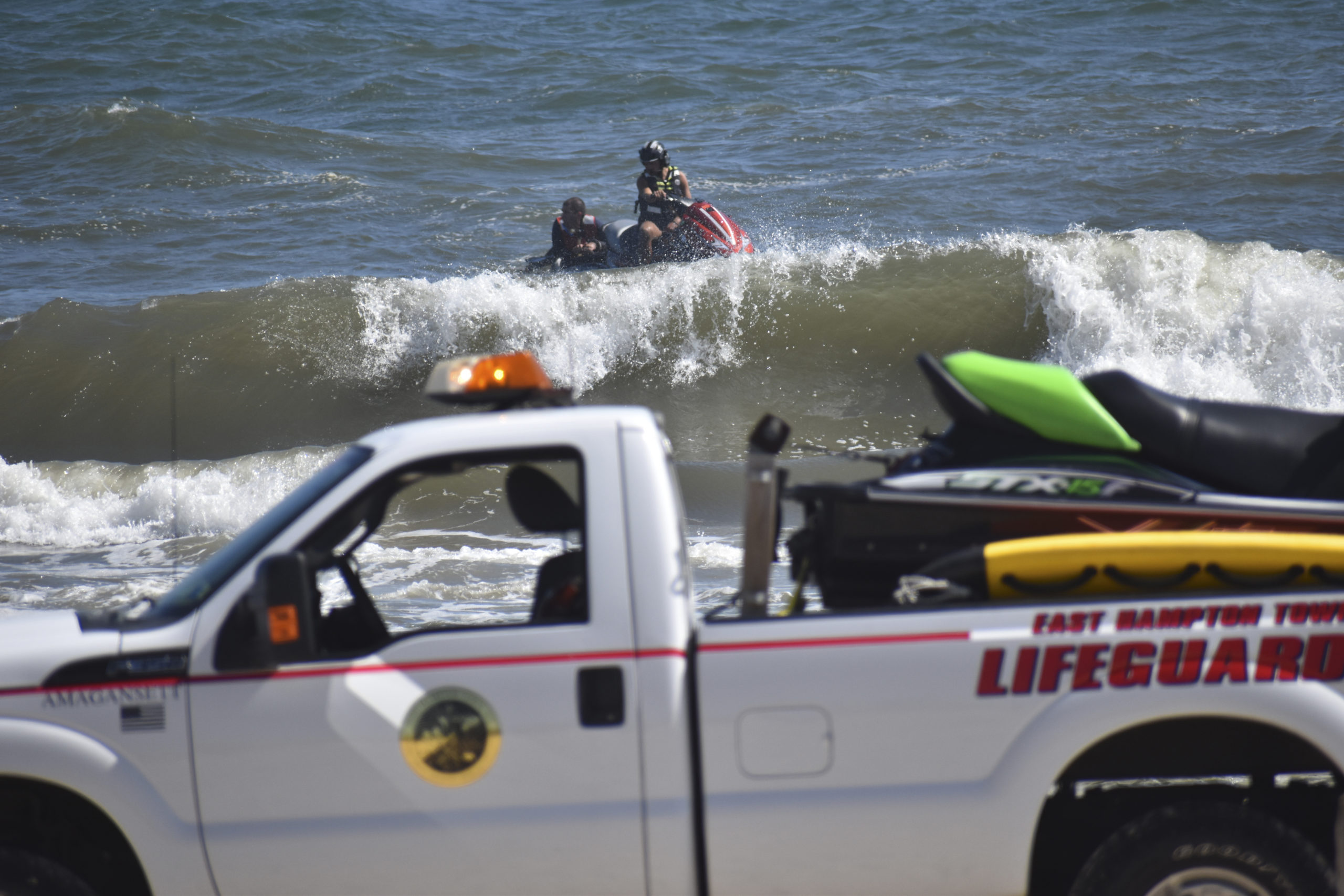 Members of the East Hampton Volunteer Ocean Rescue, police and the U.S. Coast Guard continue to search for a missing swimmer on the beach between Napeague State Park and Hither Hills Tuesday afternoon. GAVIN MENU