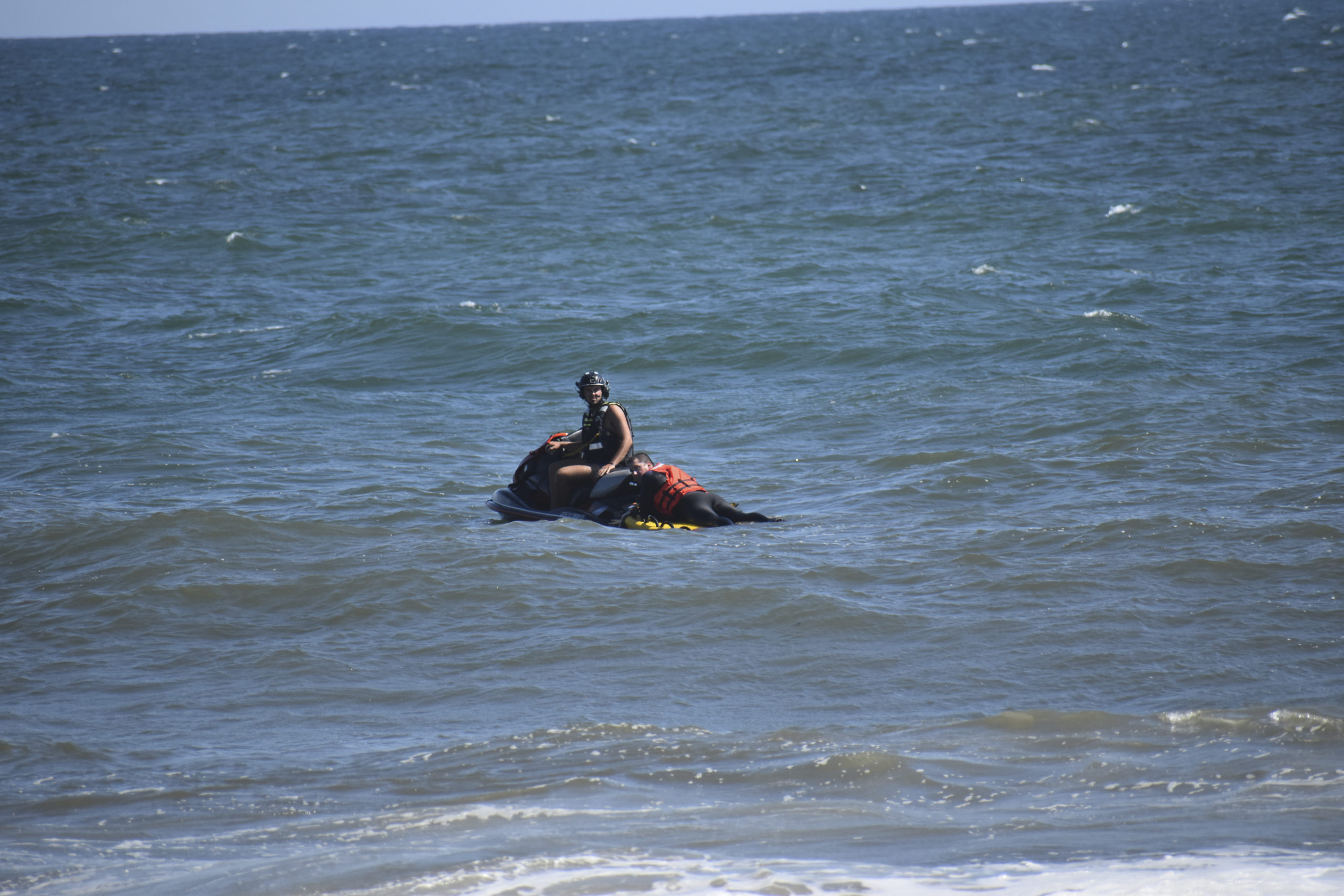 Members of the East Hampton Volunteer Ocean Rescue, police and the U.S. Coast Guard continue to search for a missing swimmer on the beach between Napeague State Park and Hither Hills Tuesday afternoon. GAVIN MENU