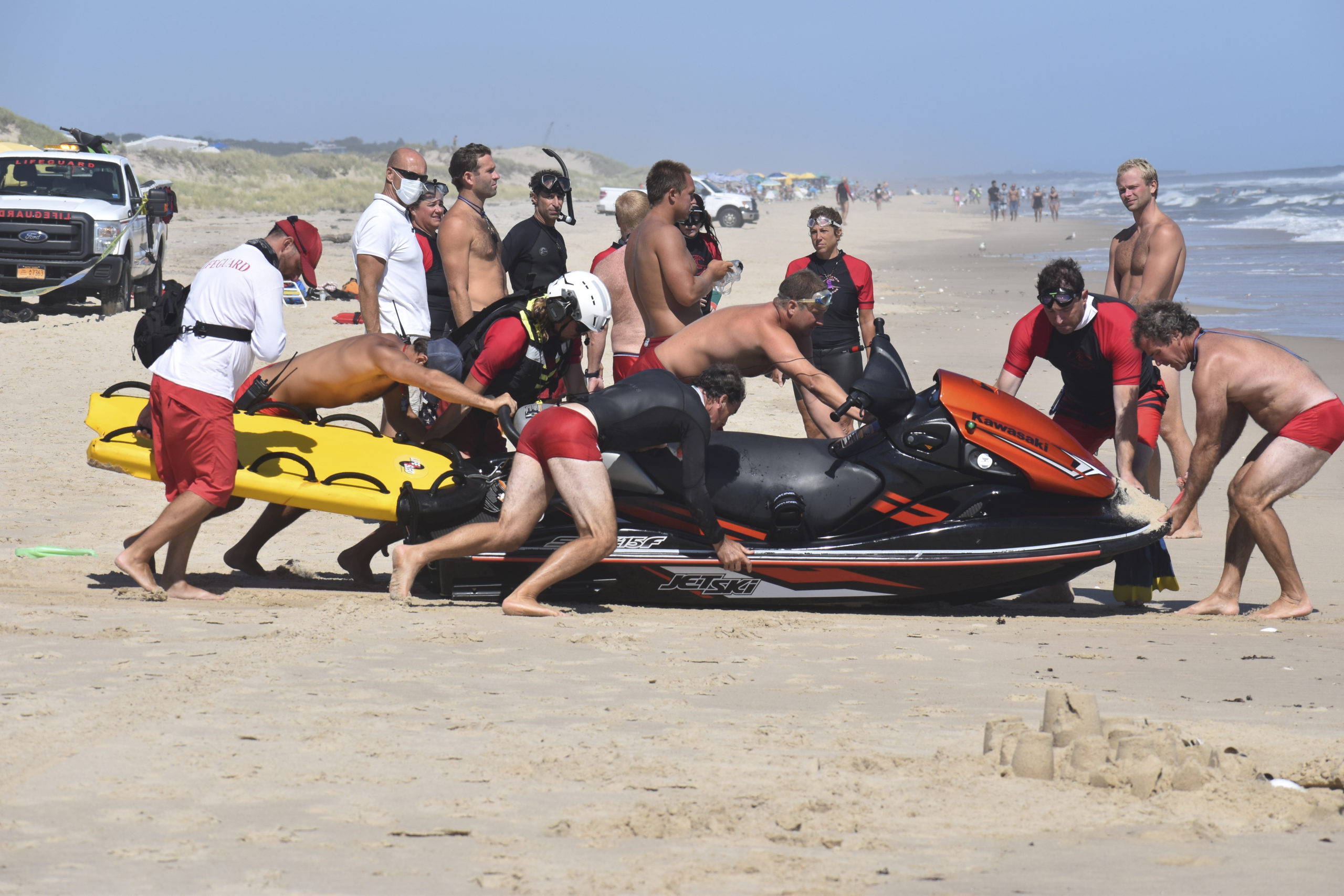 Members of the East Hampton Volunteer Ocean Rescue, police and the U.S. Coast Guard continue to search for a missing swimmer on the beach between Napeague State Park and Hither Hills Tuesday afternoon.   GAVIN MENU