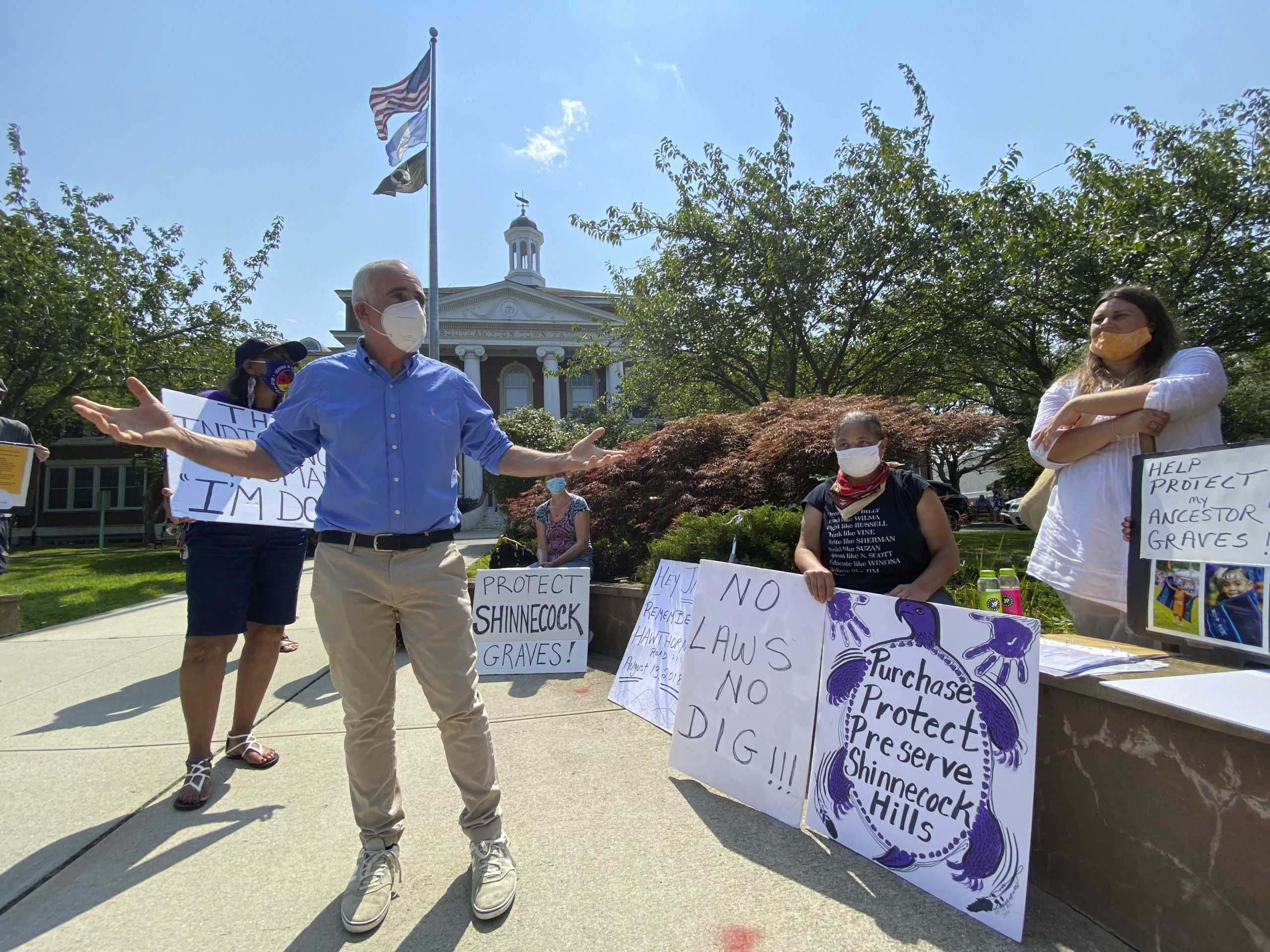 Protesters confront Southampton Town Supervisor Jay Schneiderman about the protection of Shinnecock burial sites at Southampton Town Hall on Tuesday afternoon.  DANA SHAW