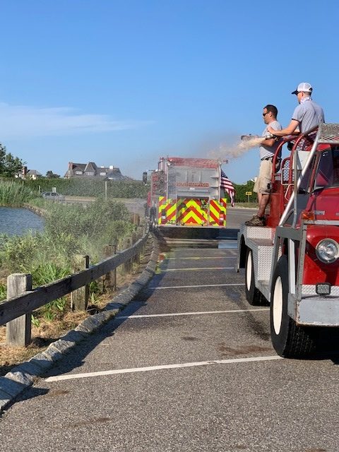 Members of the Southampton Fire Deparment have helped keep a newly planted bioswale at the foot of Lake Agawam moist during the hot, dry summer. COURTESY TONY PIAZZA