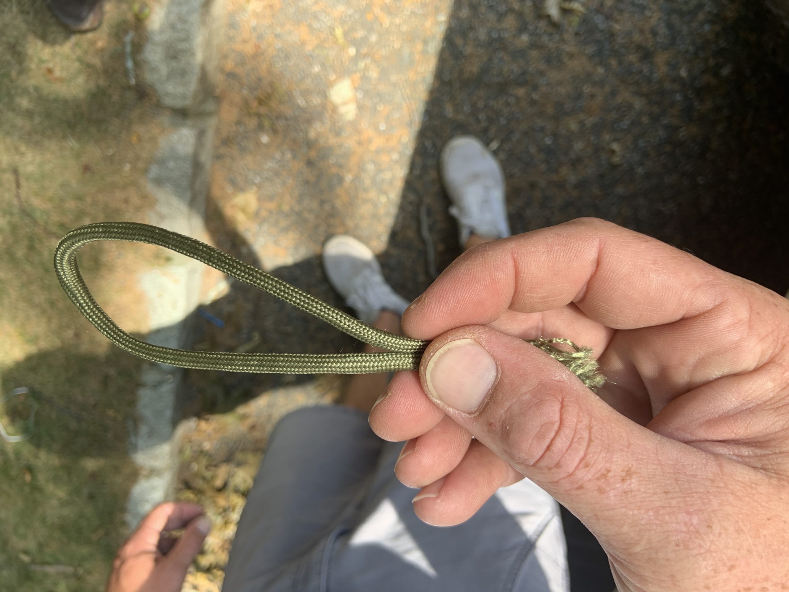 James Edler with a piece of the olive drab parachute line that was tied across a Noyac trail, injuring his son who was riding a quad. STEPHEN J, KOTZ