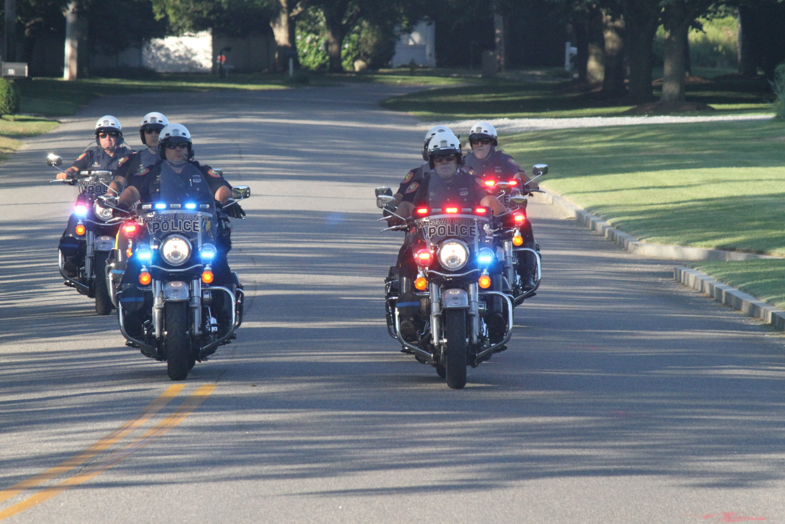 The president's motorcade and police escorts roll down Wickapogue Road in Southampton Village. 