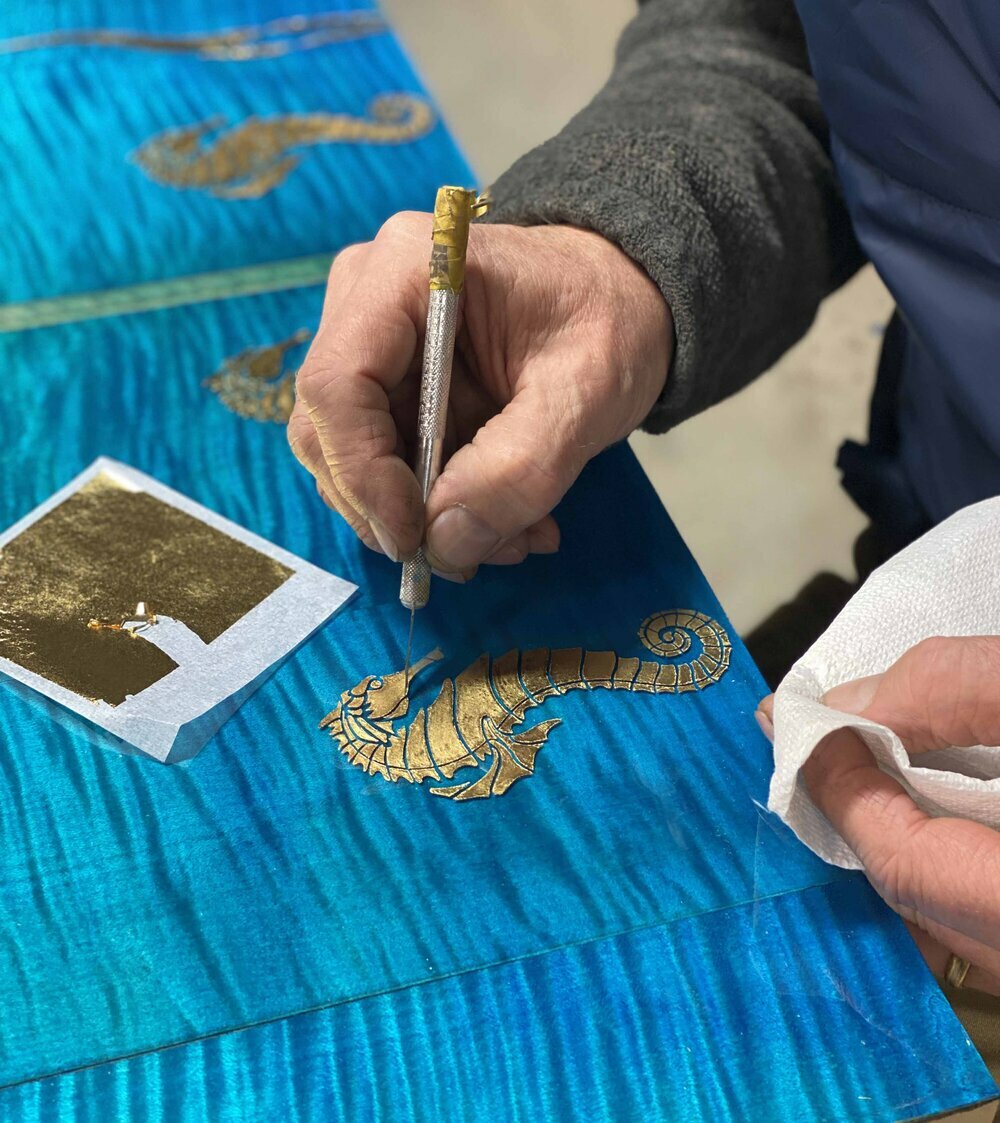 Jean-Michel Andriot handpainting details on one of his backgammon boards.