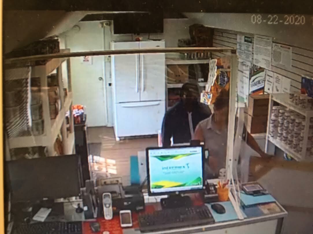 The thief guided the clerk behind the counter to the cash register. FACEBOOK VIDEO
