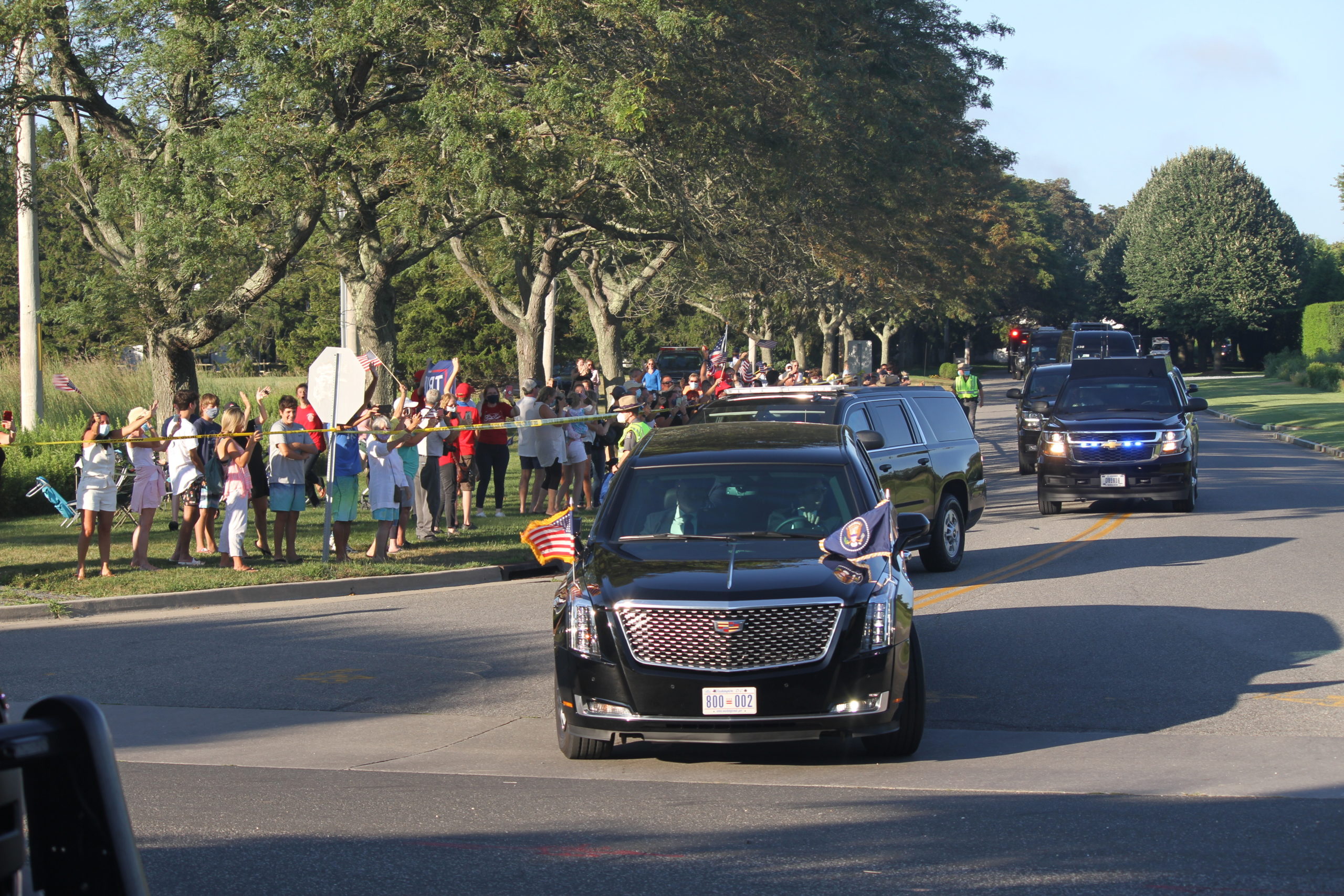 Small groups of protestors and supporters gathered along the preident's motorcade route through Southampton Village on Saturday evening. 