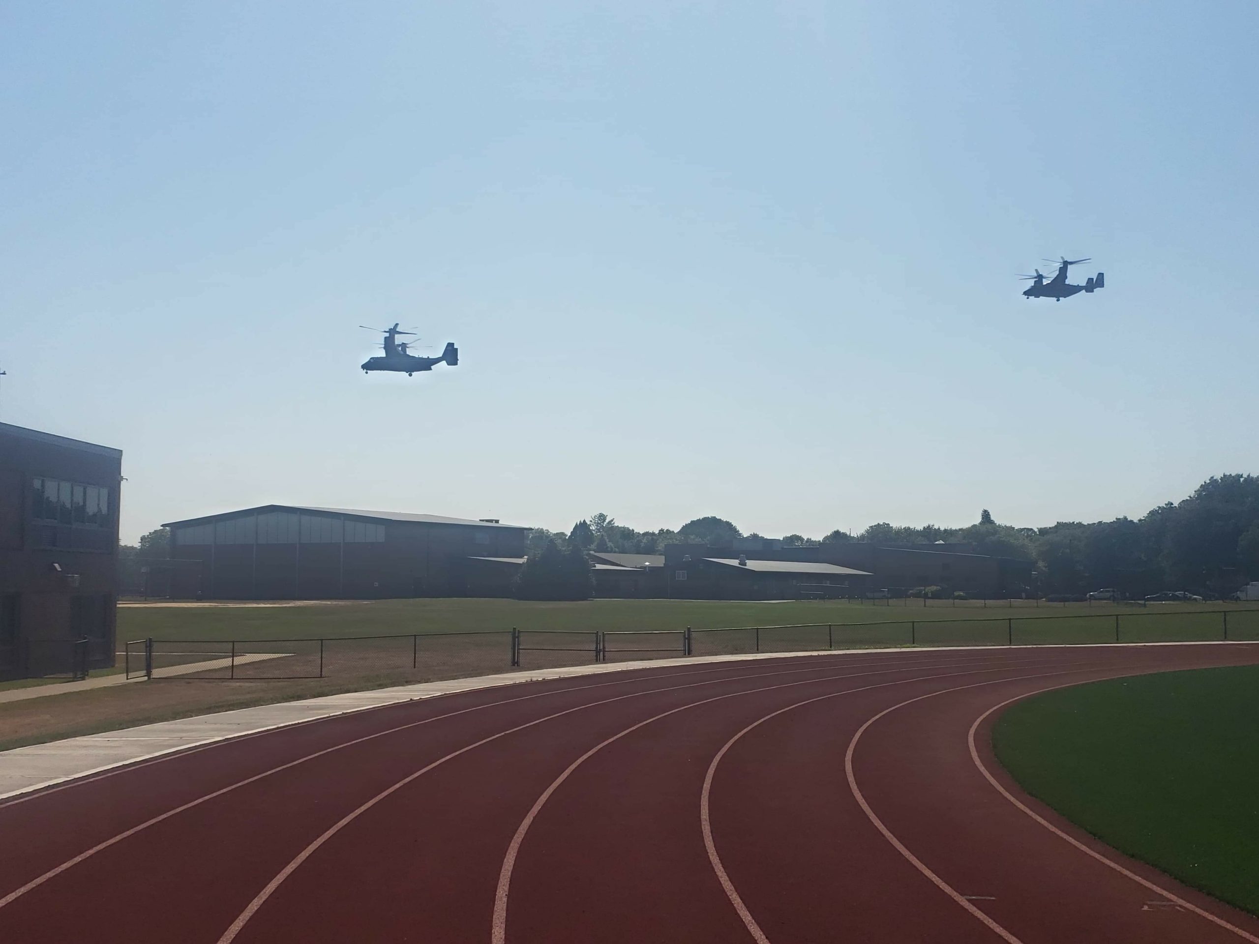 The V-22 Ospreys approach the high school. 