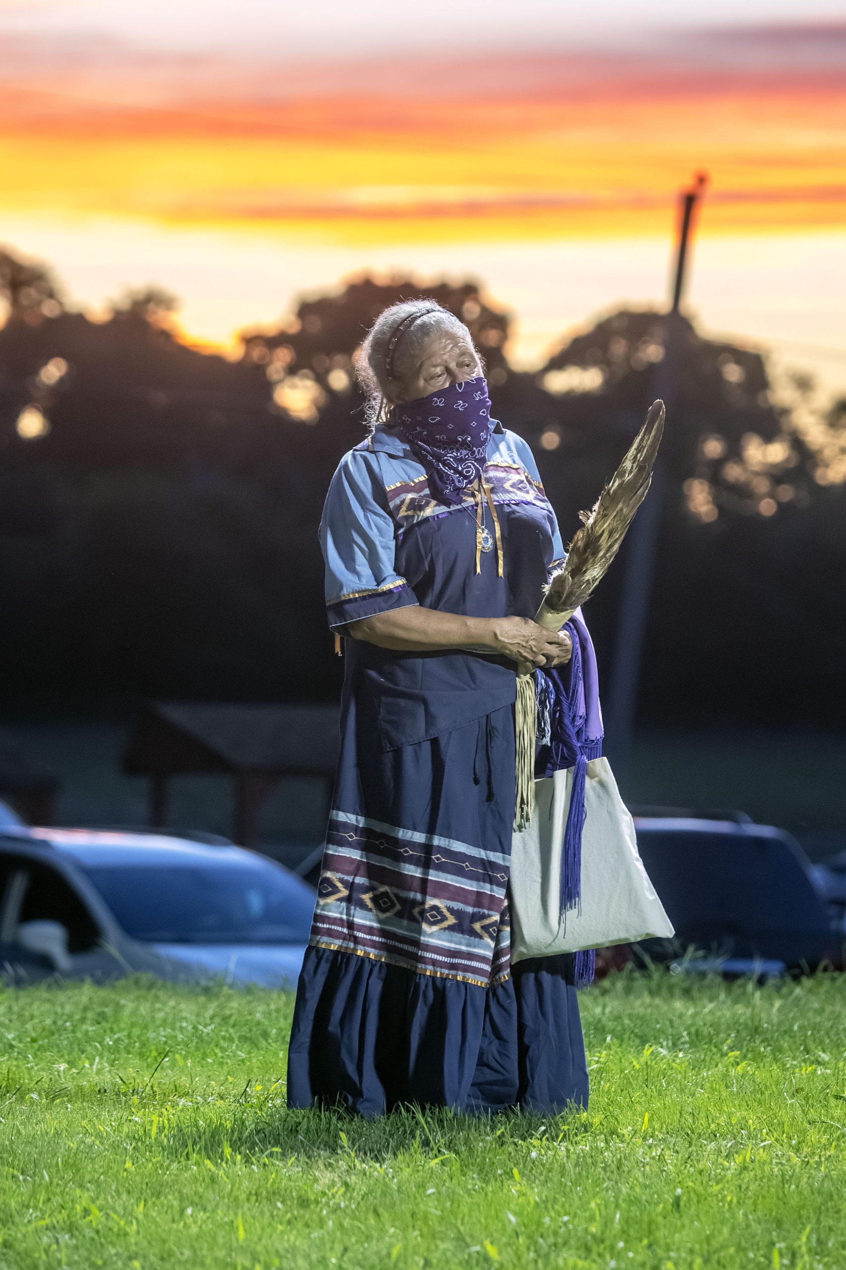 A tribe member watches as she participates in the opening ceremony of the 74th annual Shinnecock Indian Powwow on Friday night.