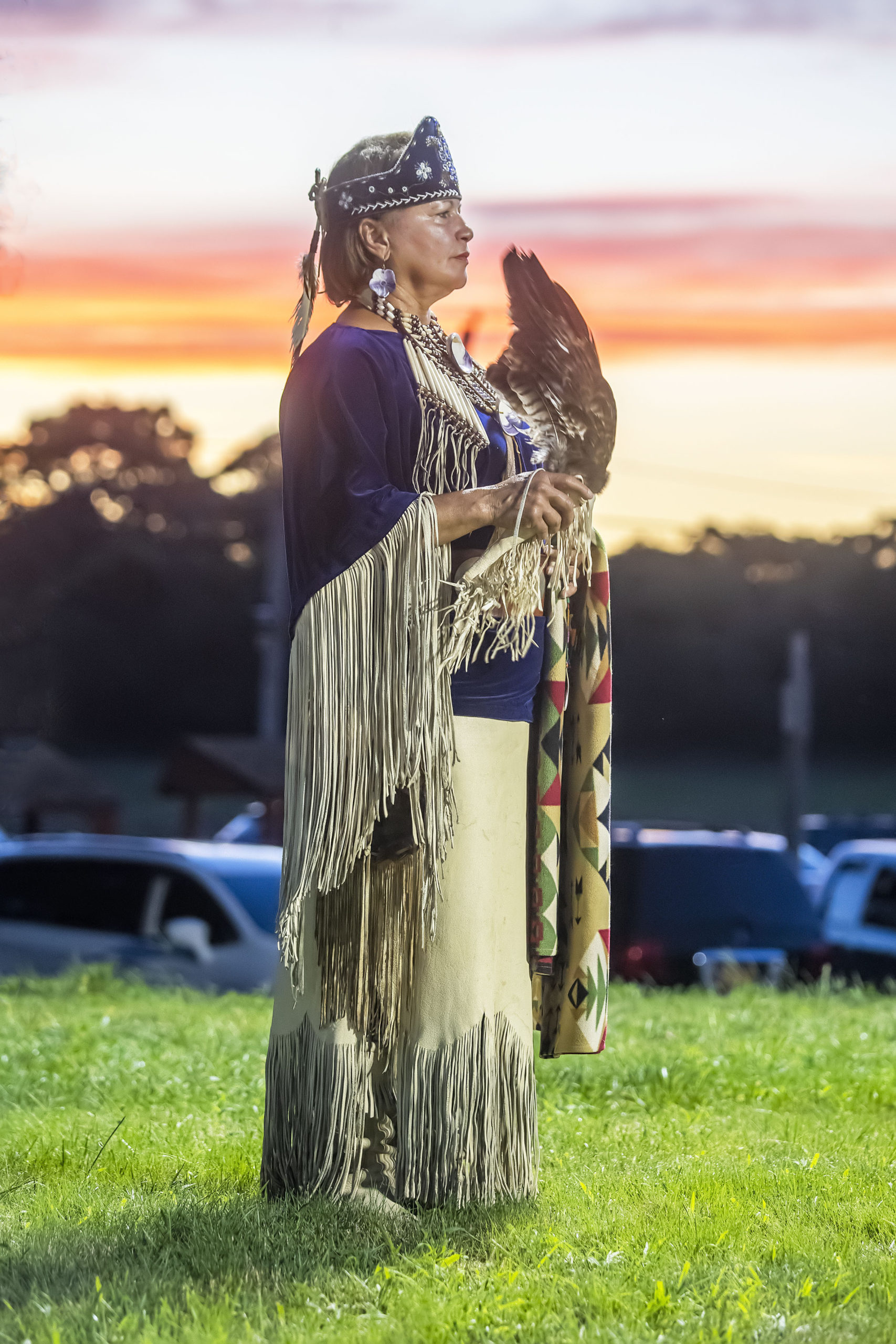 Shinnecock Nation member Karen Hunter watches as she participates in the opening ceremony of the 74th annual Shinnecock Indian Powwow on Friday night.