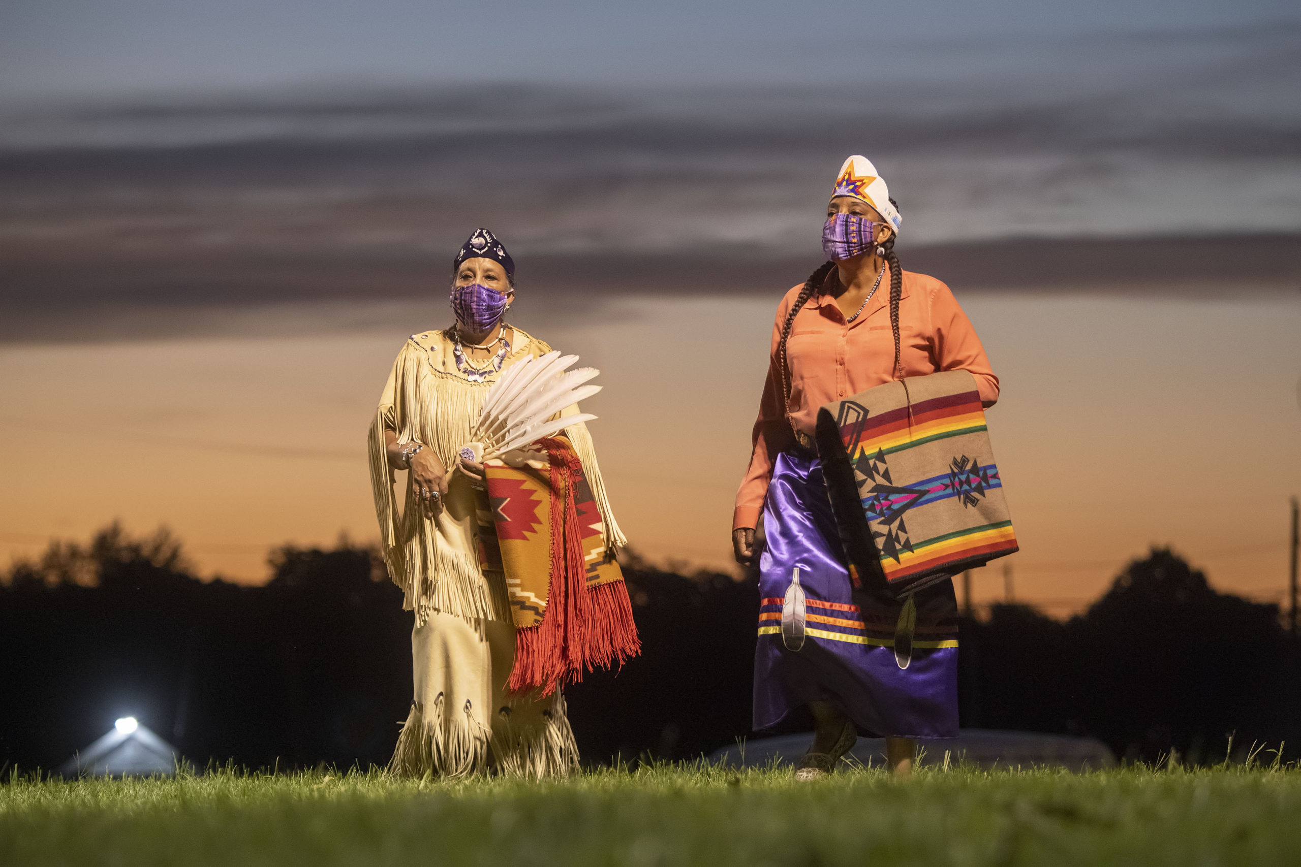 Shinnecock Nation members participate in the opening ceremony of the 74th annual Shinnecock Indian Powwow on Friday night.