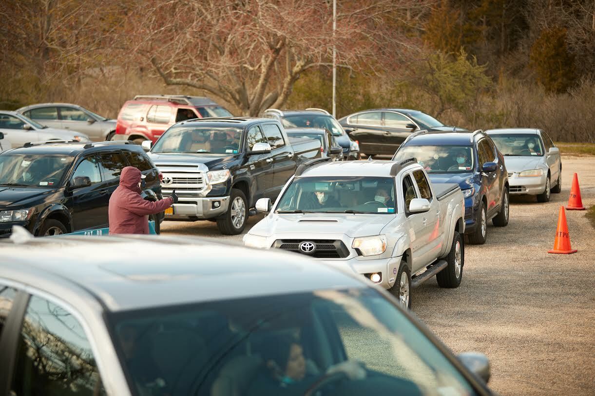 Cars filled the lot at the Springs Community Presbyterian Church with clients for the food pantry this spring.  JOHN MADERE PHOTOGRAPHY
