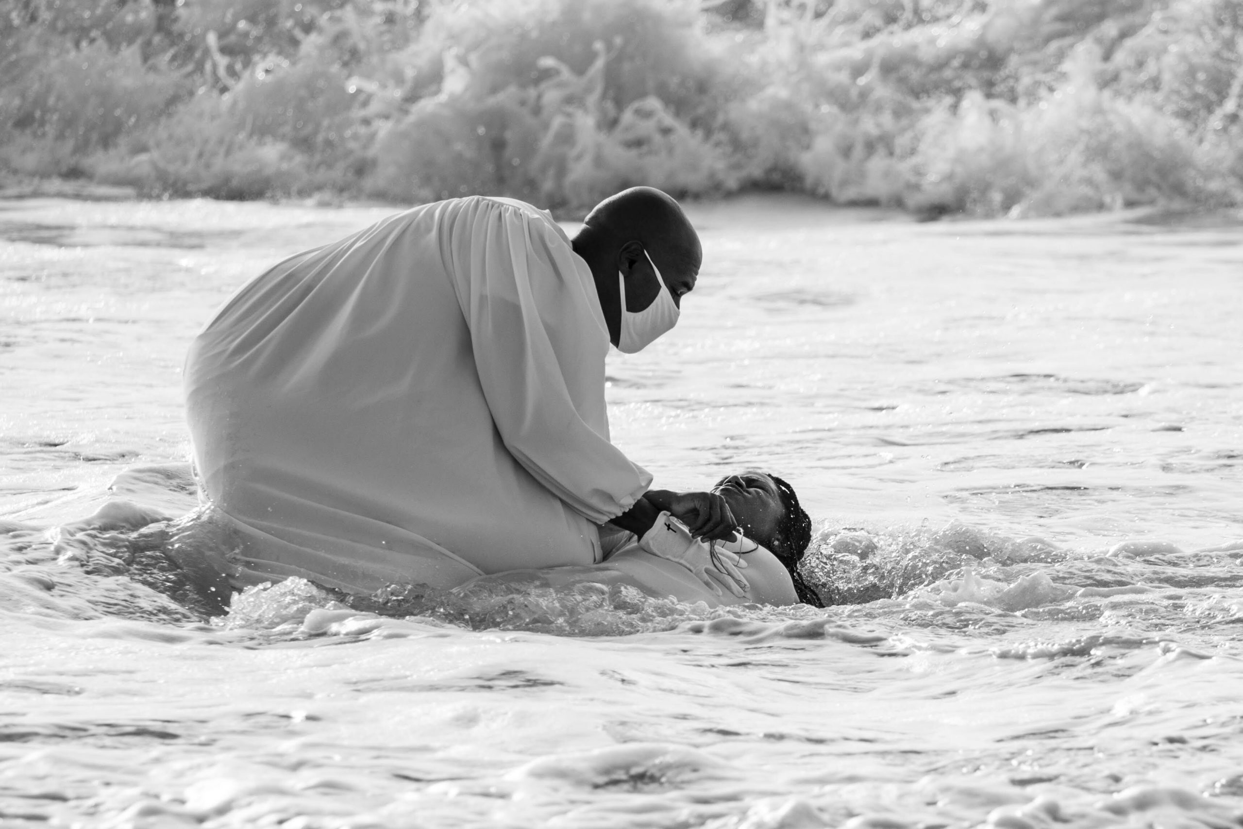 The Rev. Tisha Williams and her husband, Deacon Lawrence Williams, baptize Shakeva Brown and Delana Miller on Saturday in Bridgehampton. Both women have waited six months to be baptized as a result of the COVID-19 virus pandemic. 