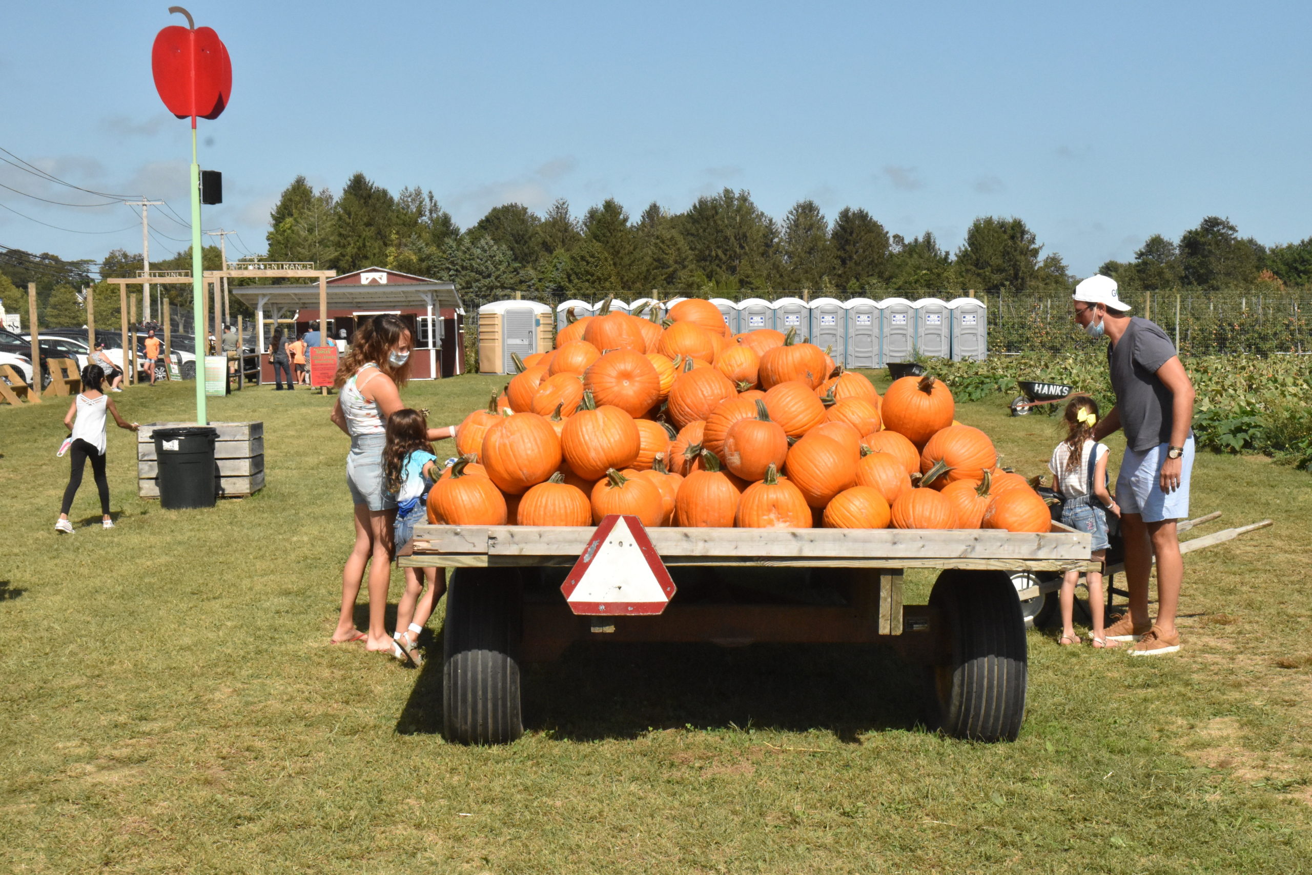A family searches for the perfect pumpkin at Hank's PumpkinTown in Water Mill on Sunday. STEPHEN J. KOTZ