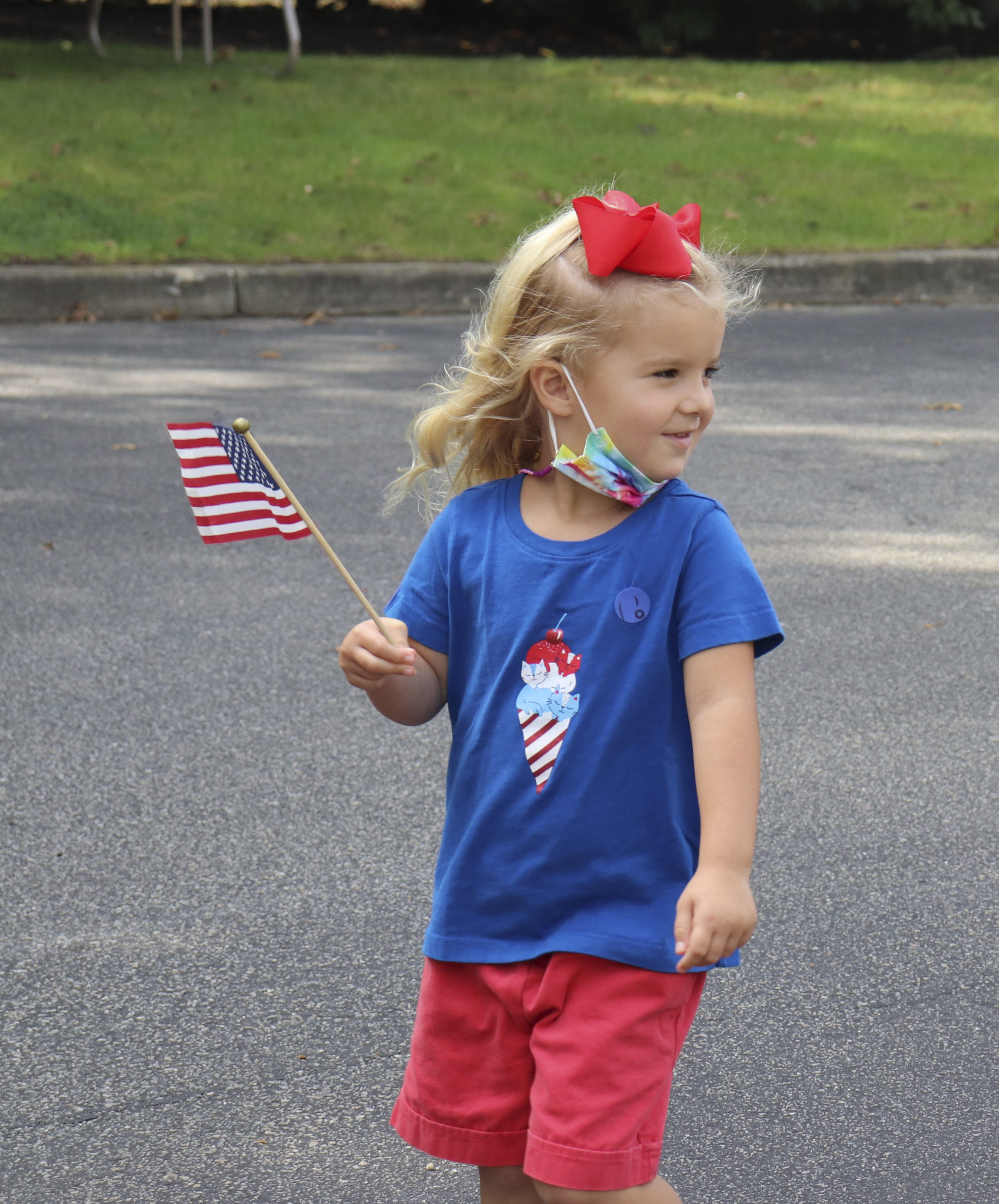 Pre-K student, Julia Cammarata marches proudly in Raynor Country Day School's parade to honor Patriot Day on Friday, September 11.    COURTESY RAYNOR COUNTRY DAY SCHOOL