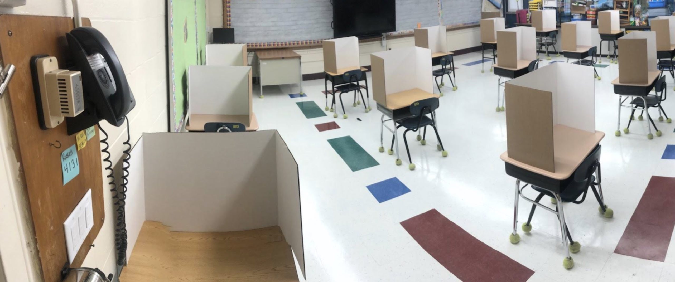 Desks in John M. Marshall Elementary School classrooms are spaced six feet apart with the surfaces surrounded by sneeze guards. 