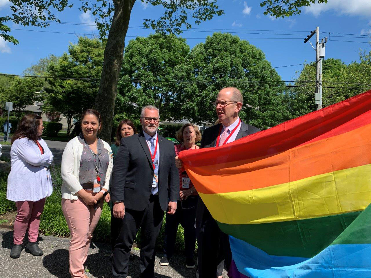 Robert S. Chaloner, Chief Administrative Officer, Stony Brook Southampton Hospital raises the rainbow flag at the hospital. COURTESY STONY BROOK SOUTHAMPTON HOSPITAL