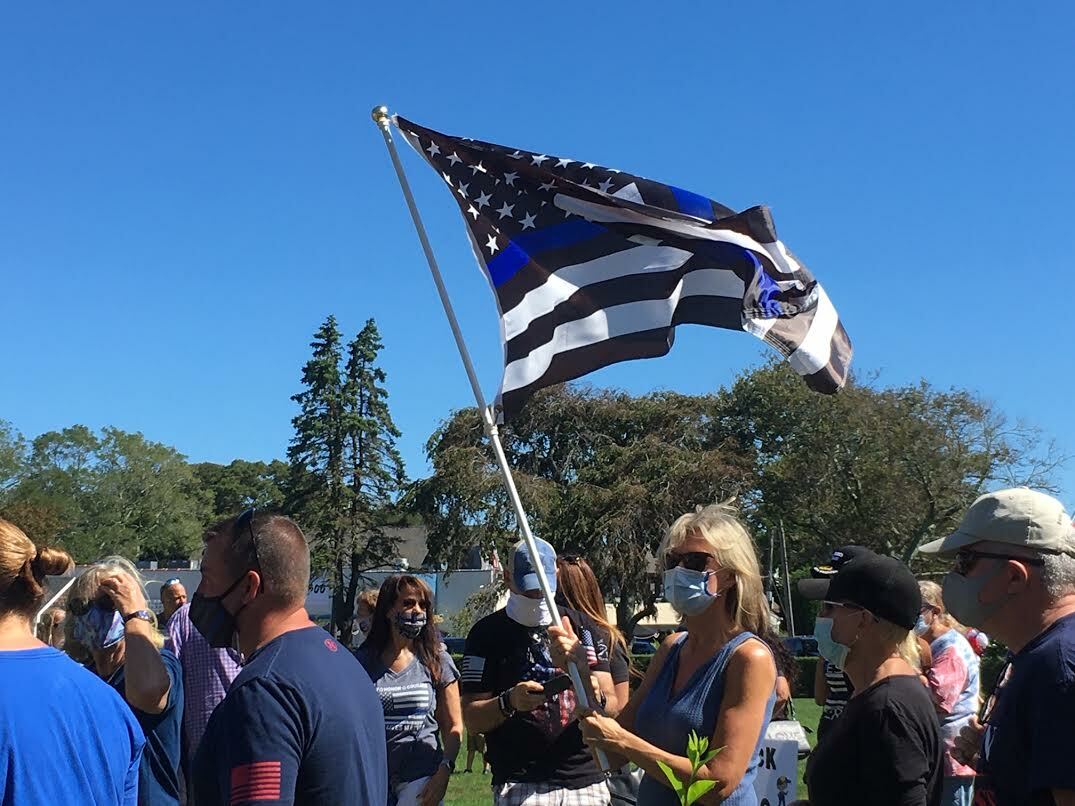 Black and blue flags were carried during the Back the Blue rally in Southampton Village Saturday. KITTYMERRILL