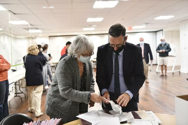 Diane Fisher, Election Inspector Chairperson and Southampton Village Administrator Russell Kratoville tabulate the machine count. DANA SHAW