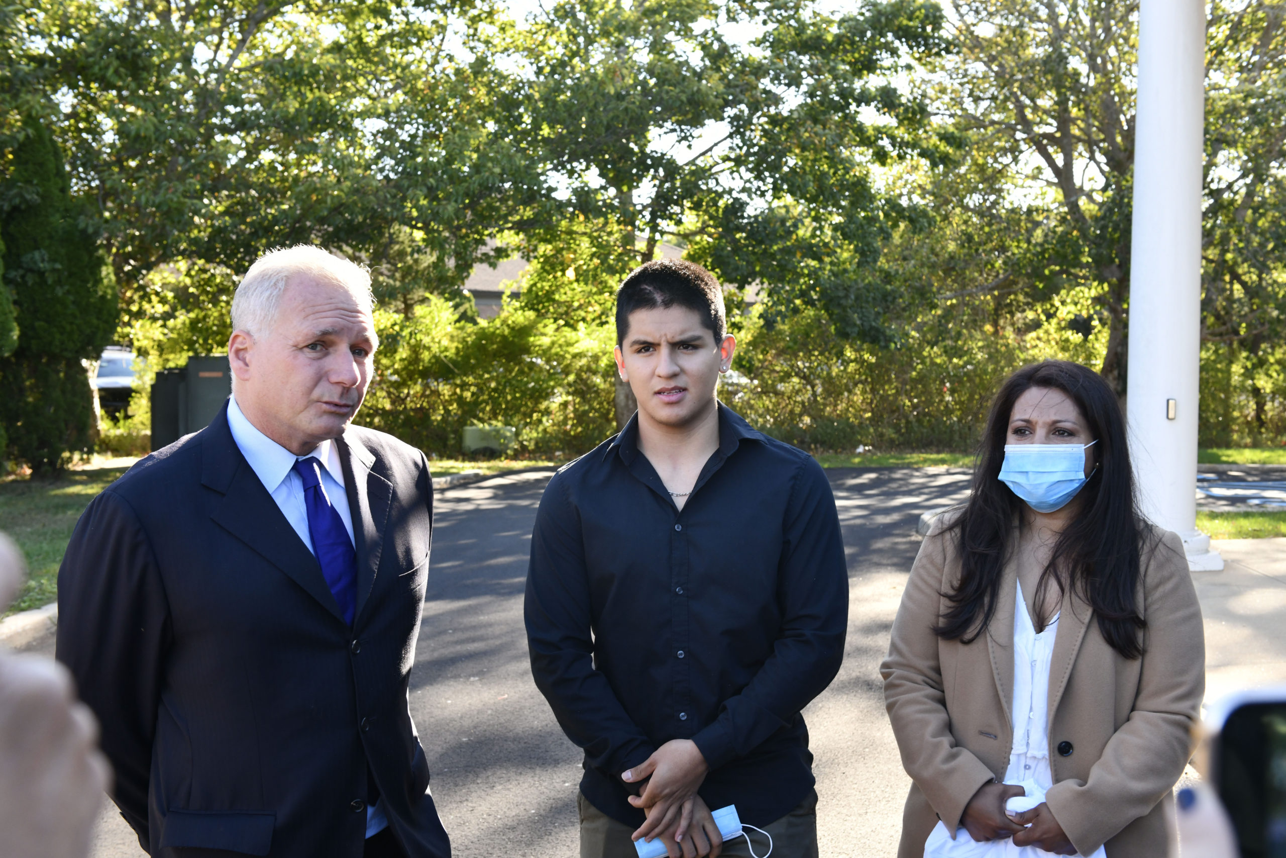Attorney Edmond C. Chakmakian, David Peralta-Mera and his mother, Jenny outside of East Hampton Town justice Court on Thursday morning.    DANA SHAW