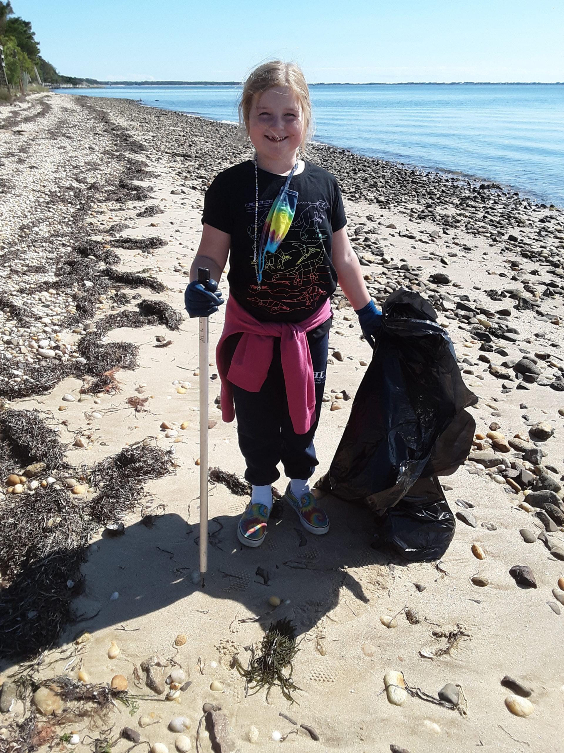 Kay Dupree assists her Grandmother during beach cleanup on Shinnecock Bay October 3 as a part of The Great East End Cleanup. 