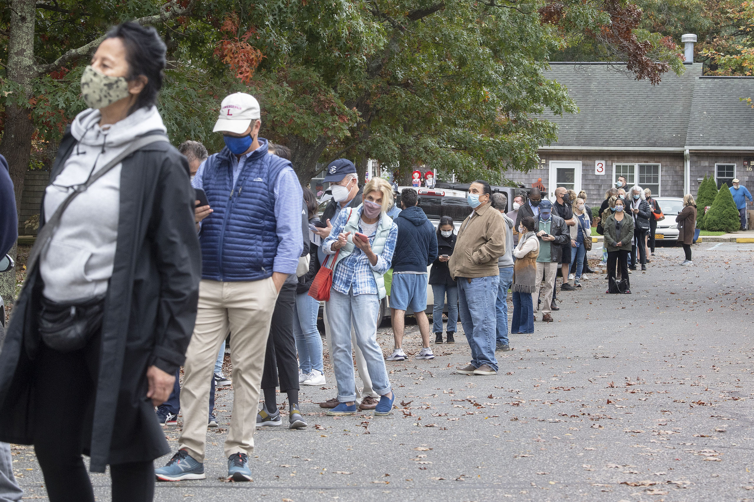 Approximately one-quarter of the first-arriving voters waiting in in line for the polling center to open during early voting at the Windmill Village complex on Accabonac Road in East Hampton on Saturday morning.  MICHAEL HELLER