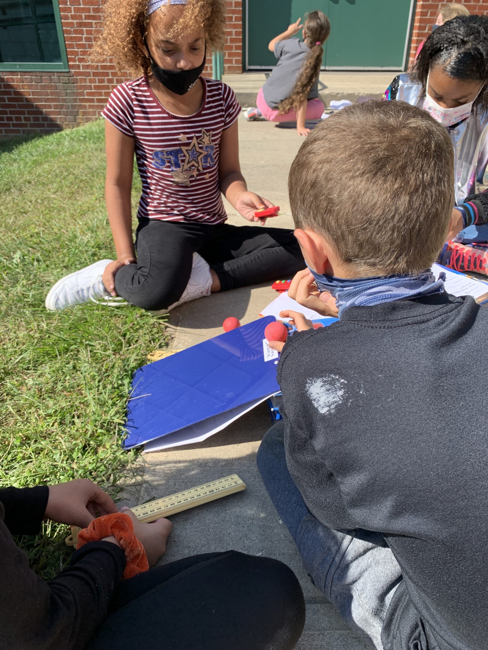 Students at East Quogue Elementary School, including Angelia Daniels, Genesis Jenkins and Marley Serrell, apply their knowledge of the scientific method and energy to conduct experiments, observing changes with thermal energy using skittles, and learned how speed is affected by height.