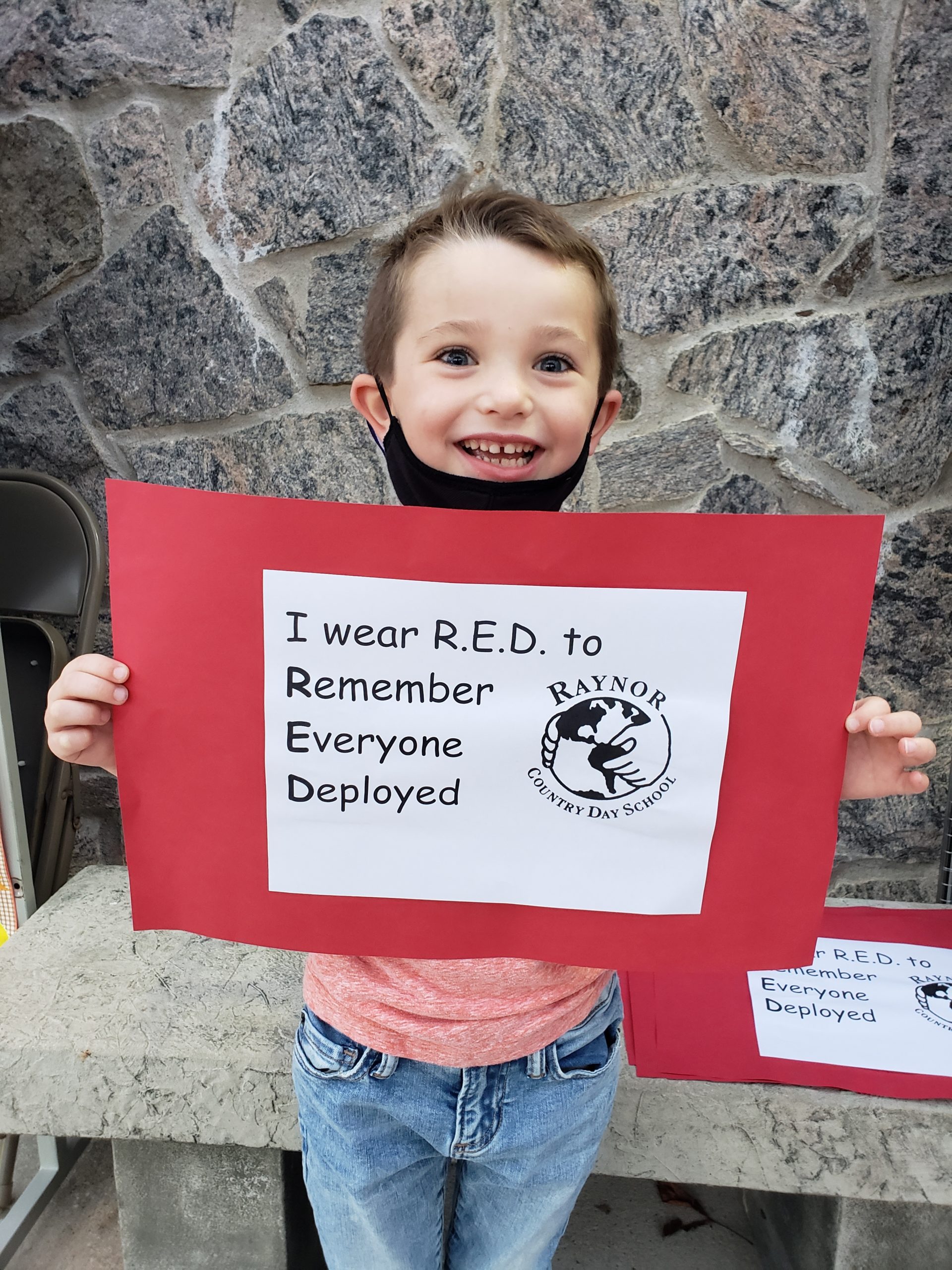 First-grade student, Christopher Lynch, remembers everyone deployed by participating in Raynor Country Day School's “Wear Red Friday!” 