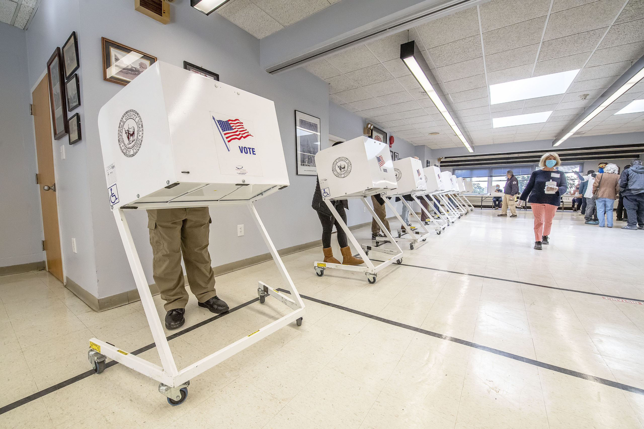 Voters fill out their ballots at the polling station at the Sag Harbor firehouse on Election Day morning.  MICHAEL HELLER