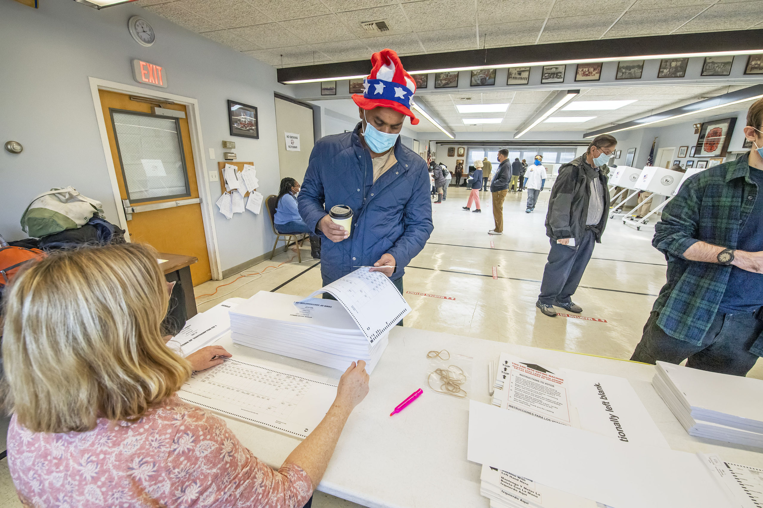 A patriotically-dressed voter picks up his ballot at the polling station at the Sag Harbor firehouse on Election Day morning.   MICHAEL HELLER