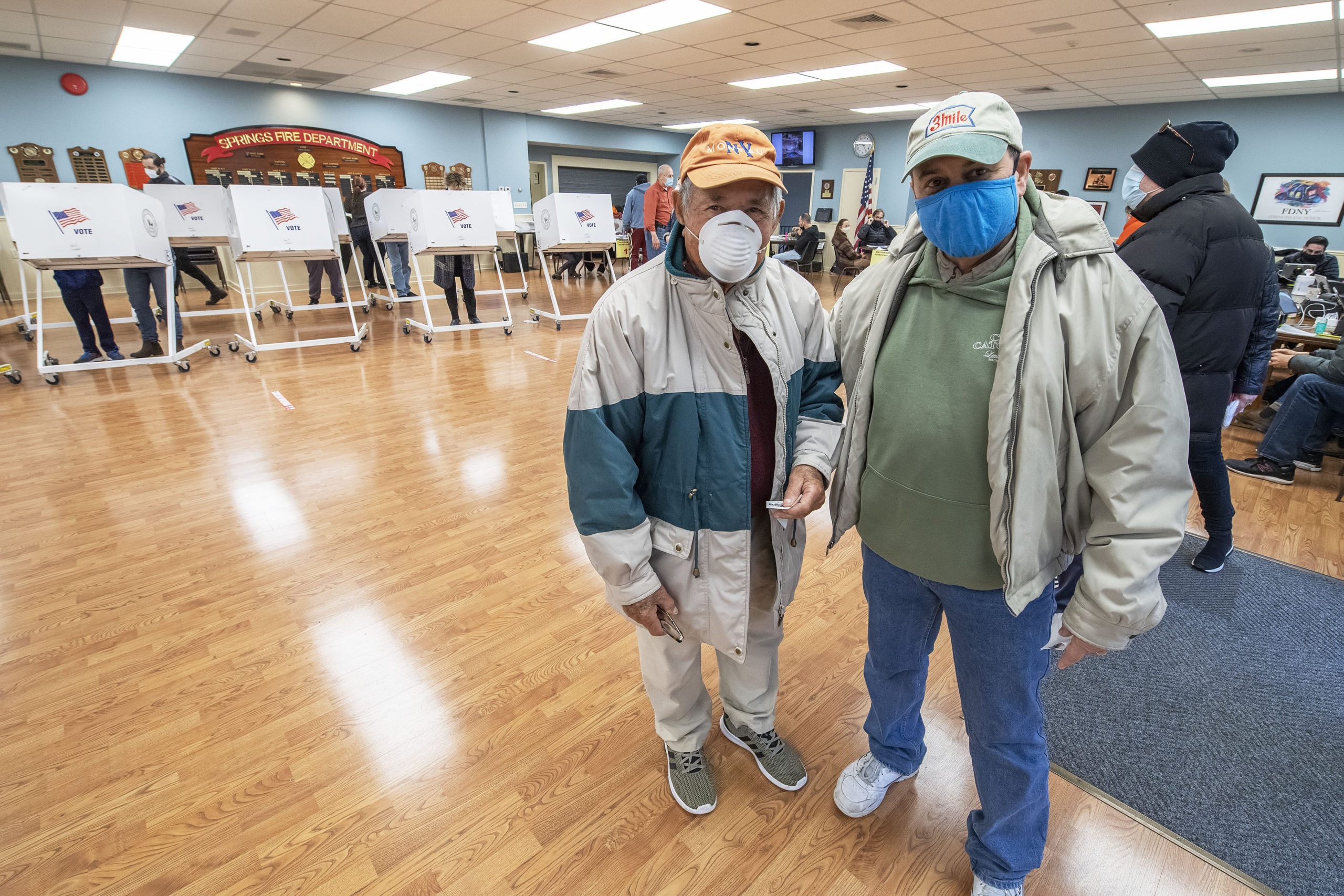 Manny Vilar, 97, at left, voted at the polling station at the Springs firehouse on Election Day morning.     MICHAEL HELLER