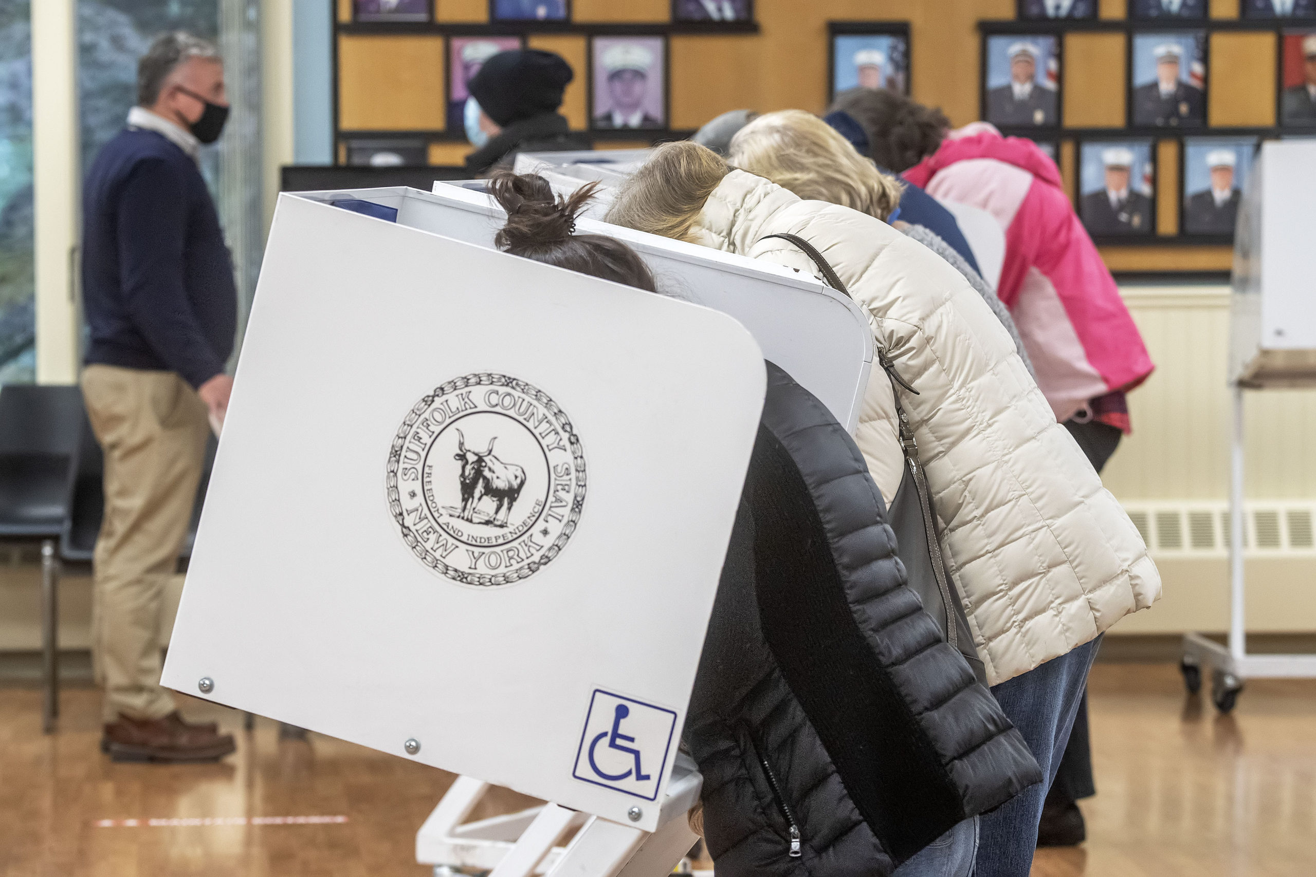 Voters at the polling station at the Springs firehouse on Election Day morning.     MICHAEL HELLER