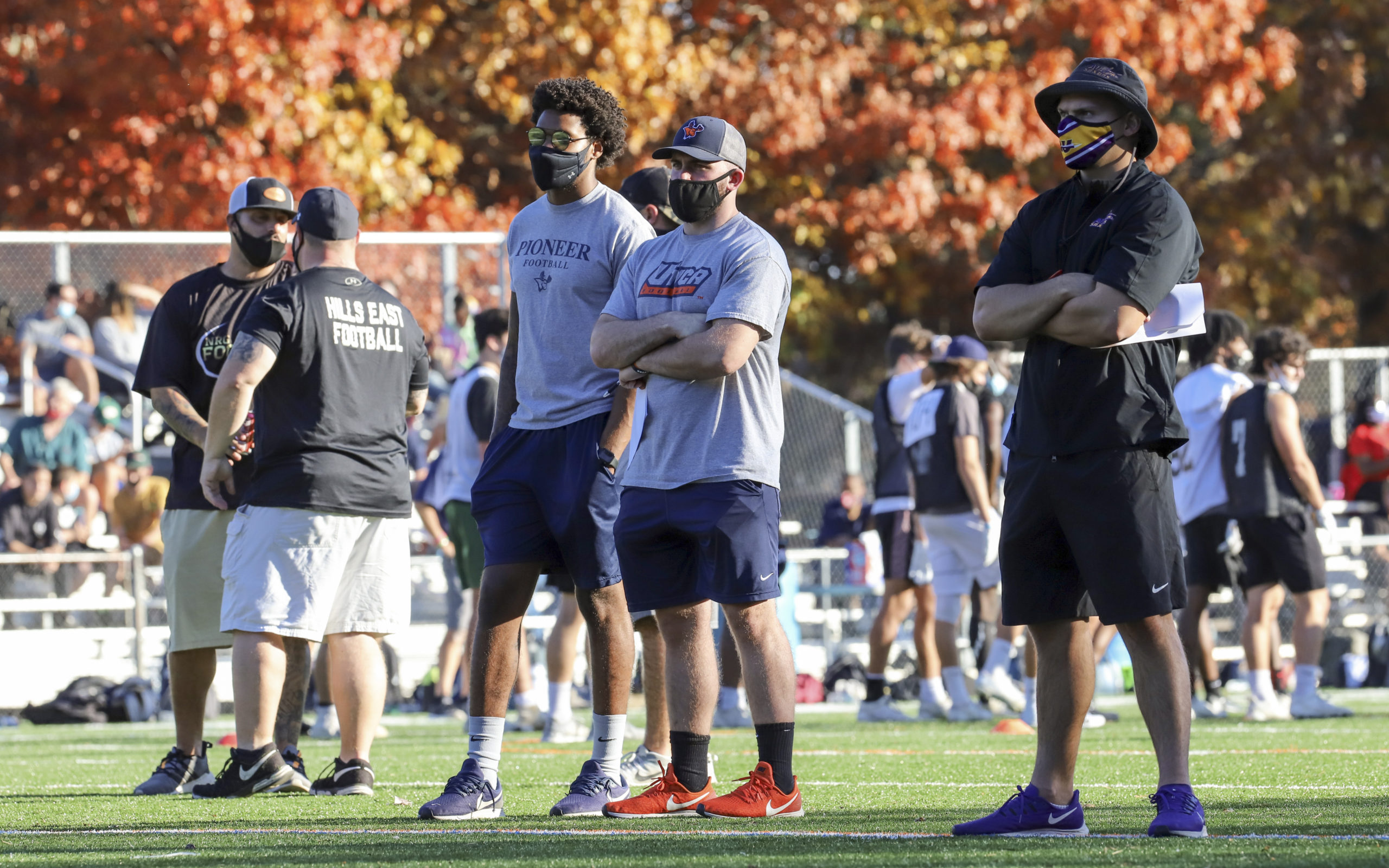 Utica College coaches Nick Woodman, the assistant coach, and Antonio Scala, the assistant coach of linebackers, and Alfred University special teams coordinator and defensive backs coach Holden Whitehead scout players during the Suffolk County Football Coaches Association's seventh annual showcase November 8.   CHRISTINE HEEREN