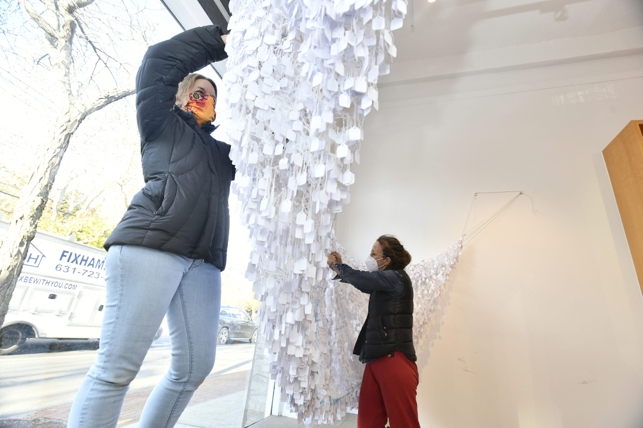 Kerry Sharkey-Miller and artist Alice Hope work on installing Hope's work 