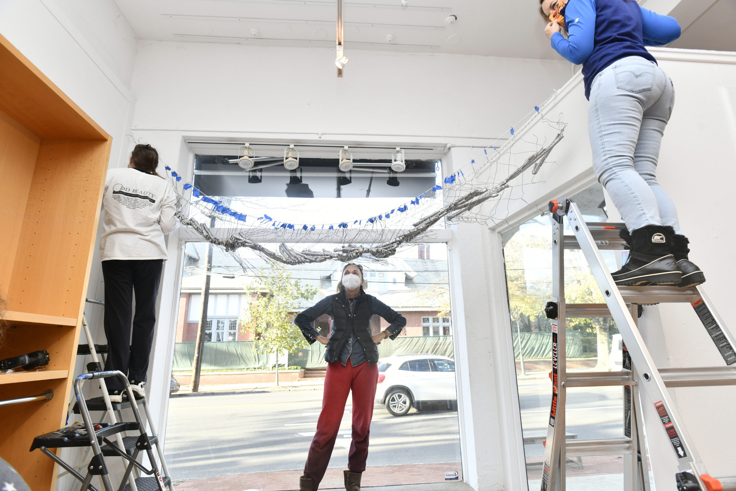 Lisa Weston, artist Alice Hope  and Lisa Sharkey-Miller work on installing Hope's work 