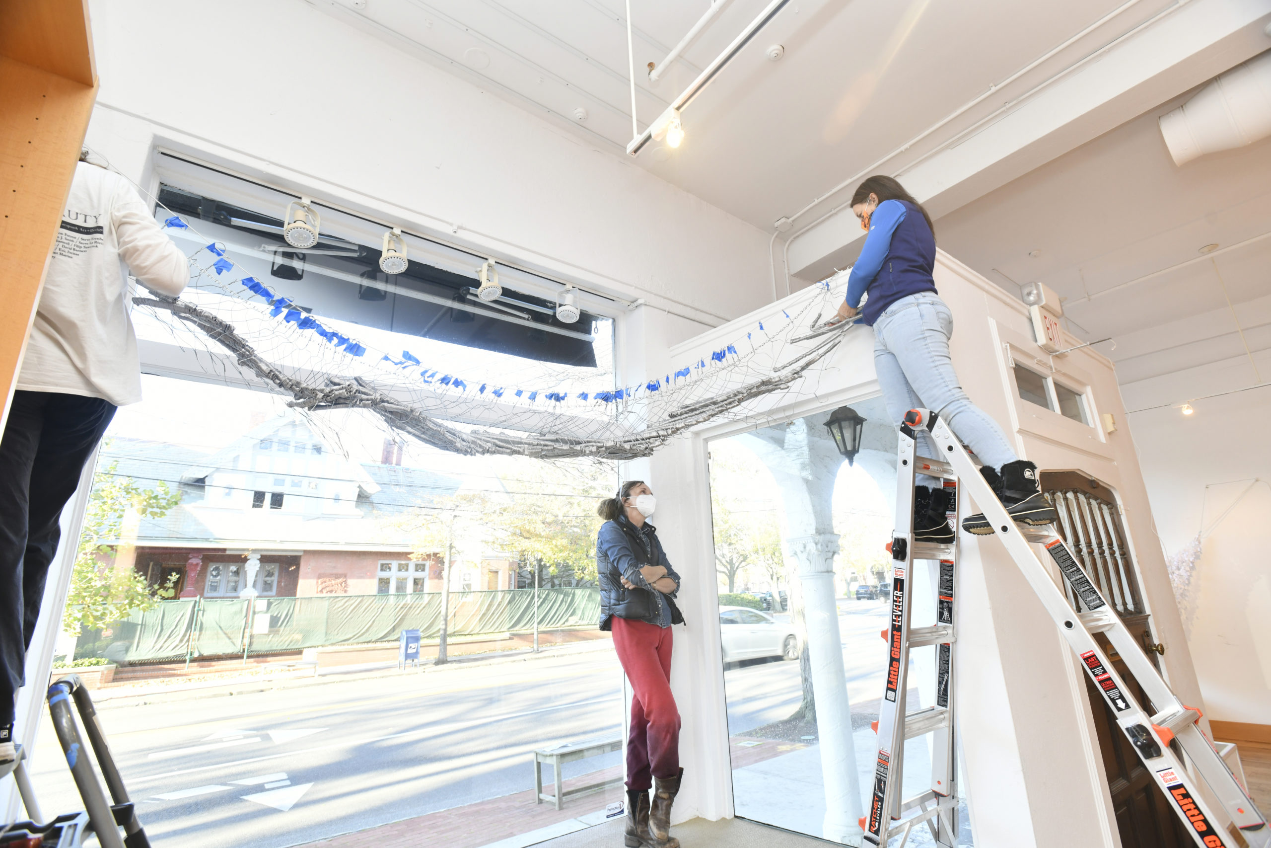 Lisa Weston, artist Alice Hope  and Lisa Sharkey-Miller work on installing Hope's work 