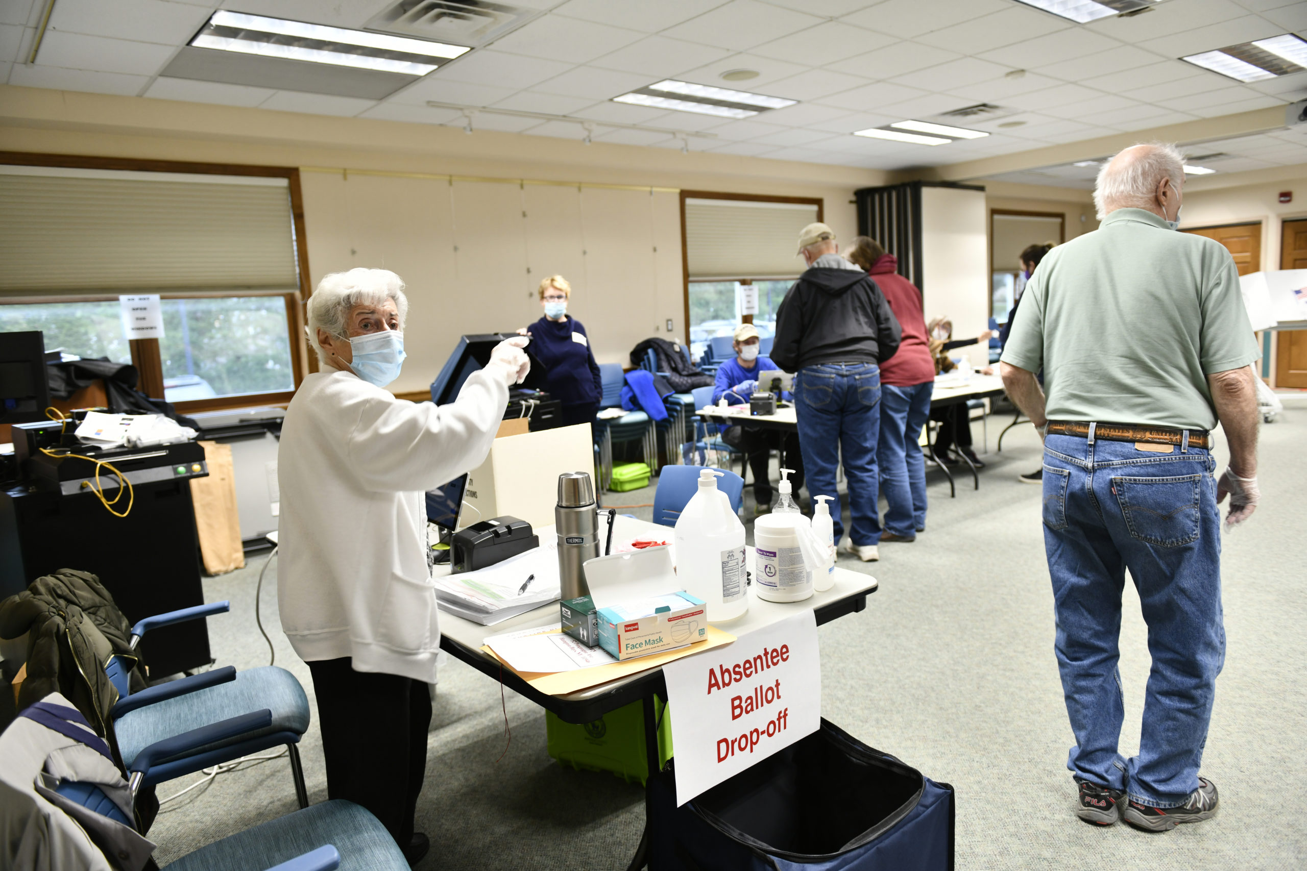 Polling Place Coordinator Mella Burke directs a voter  at the Hampton Bays Library on tuesday morning.   DANA SHAW